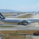 Osaka, Japan: A long-haul flight operated by Cathay Pacific diverted to Japan on April 7 after the crew detected an abnormal engine indication while en route from Los Angeles to Hong Kong, triggering a precautionary emergency response. Flight CX883, operated by a Boeing 777-300ER, was carrying 370 passengers and crew when cockpit systems indicated a drop in engine oil levels during cruise over the Pacific Ocean. Such alerts are treated with high priority in commercial aviation due to their potential implications for engine performance and long-range flight safety. The flight crew initiated standard emergency protocols and diverted the aircraft to Kansai International Airport, one of the nearest suitable diversion airports capable of handling widebody operations. The aircraft landed safely at approximately 4:30 a.m. local time. No injuries were reported, and passengers disembarked normally. In a statement, Cathay Pacific said the diversion was conducted “in accordance with established safety procedures,” emphasizing that safety remains its top operational priority. The airline confirmed that the aircraft has been withdrawn from service pending a comprehensive technical inspection by engineering teams to determine the cause of the engine oil indication. The airline arranged alternative flights to Hong Kong, but the sudden influx of disrupted passengers placed pressure on ground handling resources at Kansai. The incident caused minor delays to another flight at Kansai International Airport due to the emergency landing. Cathay Pacific has initiated a technical investigation into the incident. Engineers will examine the affected engine system, review flight data, and determine whether the issue stemmed from a mechanical fault, sensor anomaly, or other contributing factors.