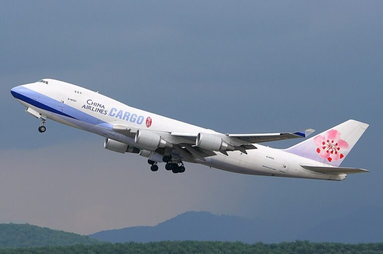 Whitehorse, Canada: A China Airlines cargo aircraft was forced to make an emergency diversion to northern Canada after a smoke alarm was triggered mid-flight, prompting a precautionary response from the flight crew. The incident occurred on April 18, 2026, when a China Airlines Boeing 747-400 freighter was en route on a trans-Pacific cargo sector and experienced a cockpit warning indicating possible smoke onboard. The crew responded in line with standard aviation safety procedures by declaring an emergency and diverting the aircraft to Erik Nielsen Whitehorse International Airport, the nearest suitable airport along its route. The aircraft landed safely in Whitehorse, with emergency services on standby as a precaution. Authorities confirmed that there were no injuries among crew members, and no visible signs of fire or smoke were detected after landing. Initial reports indicate that the smoke warning originated from onboard detection systems, which are designed to trigger alerts even in the absence of an actual fire. Aviation protocols require immediate action in such scenarios due to the high risk associated with in-flight cargo fires. The cargo jet was reportedly operating a Chicago-Anchorage route, part of a common polar cargo corridor used for trans-Pacific freight operations. Whitehorse frequently serves as an alternate diversion airport for aircraft operating in northern airspace due to its strategic location and long runway capability. Following the landing, the aircraft underwent inspection on the ground in Whitehorse. While authorities have not publicly confirmed the exact cause of the warning, early indications suggest the alert may have been precautionary rather than linked to an active onboard fire. The aircraft was later cleared to depart after necessary checks were completed.