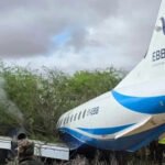 Mandera, Kenya: An EBB Air Embraer aircraft operating on the Nairobi-Mandera route veered off the runway during landing at Mandera Airstrip on Friday morning, in a runway excursion incident that triggered an emergency response but left all passengers and crew safe. According to confirmations from aviation authorities and multiple reports, the aircraft departed from Jomo Kenyatta International Airport (JKIA) in Nairobi at around 6:55–6:56 a.m. carrying 32 passengers and 4 crew members, before arriving in Mandera at approximately 8:30–9:10 a.m. local time. Preliminary reports indicate that the aircraft lost control after touchdown and overran the runway, eventually coming to rest in nearby vegetation or bushes beyond the paved surface of the airstrip. Images circulating from the scene show the aircraft partially embedded in bushy terrain, with its fuselage extending off the runway area. Some visuals also indicated light smoke from the aircraft’s structure following the impact. All 36 occupants were safely evacuated with the assistance of ground emergency teams deployed immediately after the incident. Authorities confirmed that no fatalities or injuries occurred, despite significant damage to the aircraft. The Kenya Airports Authority (KAA) stated that rescue teams responded promptly and secured the scene shortly after the aircraft came to a stop near the airstrip perimeter. The aircraft involved is reported to be an Embraer regional aircraft operated by EBB Air, identified in some aviation records as registration 5Y-EBB. The flight was a scheduled domestic service connecting Nairobi and Mandera, a route that serves government, humanitarian, and commercial travel in Kenya’s northeastern region. Aviation authorities have launched an investigation to determine the cause of the runway excursion. While the exact reason has not been confirmed, early considerations include landing conditions, runway surface factors, or possible technical issues. No official conclusion has yet been issued. The Mandera Airstrip, located near the Kenya–Somalia–Ethiopia border region, is known for handling limited traffic, primarily charter, humanitarian, and regional domestic flights.