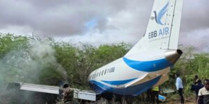 Mandera, Kenya: An EBB Air Embraer aircraft operating on the Nairobi-Mandera route veered off the runway during landing at Mandera Airstrip on Friday morning, in a runway excursion incident that triggered an emergency response but left all passengers and crew safe. According to confirmations from aviation authorities and multiple reports, the aircraft departed from Jomo Kenyatta International Airport (JKIA) in Nairobi at around 6:55–6:56 a.m. carrying 32 passengers and 4 crew members, before arriving in Mandera at approximately 8:30–9:10 a.m. local time. Preliminary reports indicate that the aircraft lost control after touchdown and overran the runway, eventually coming to rest in nearby vegetation or bushes beyond the paved surface of the airstrip. Images circulating from the scene show the aircraft partially embedded in bushy terrain, with its fuselage extending off the runway area. Some visuals also indicated light smoke from the aircraft’s structure following the impact. All 36 occupants were safely evacuated with the assistance of ground emergency teams deployed immediately after the incident. Authorities confirmed that no fatalities or injuries occurred, despite significant damage to the aircraft. The Kenya Airports Authority (KAA) stated that rescue teams responded promptly and secured the scene shortly after the aircraft came to a stop near the airstrip perimeter. The aircraft involved is reported to be an Embraer regional aircraft operated by EBB Air, identified in some aviation records as registration 5Y-EBB. The flight was a scheduled domestic service connecting Nairobi and Mandera, a route that serves government, humanitarian, and commercial travel in Kenya’s northeastern region. Aviation authorities have launched an investigation to determine the cause of the runway excursion. While the exact reason has not been confirmed, early considerations include landing conditions, runway surface factors, or possible technical issues. No official conclusion has yet been issued. The Mandera Airstrip, located near the Kenya–Somalia–Ethiopia border region, is known for handling limited traffic, primarily charter, humanitarian, and regional domestic flights.