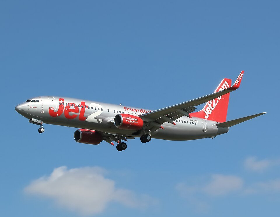 Manchester, United Kingdom: A Jet2 passenger aircraft bound for the Greek island of Crete was forced to carry out an emergency landing at Manchester Airport after it was struck by a flock of geese shortly after take-off, leading to a precautionary diversion and a rapid response from the flight crew. The incident occurred during the initial climb phase of the flight, when the aircraft encountered a bird strike involving geese. Due to the size and potential impact of such birds, the crew immediately assessed the situation for any possible engine or structural damage before deciding to return to the departure airport as a safety precaution. Following standard aviation procedures, the pilots declared an emergency and coordinated with air traffic control to prioritise an immediate return. The aircraft safely landed without further incident, and no injuries were reported among passengers or crew on board. Emergency services were placed on standby as a precautionary measure in line with airport emergency response protocols. However, their intervention was not required after the aircraft came to a safe stop on the runway. Passengers were safely disembarked after landing, and airline staff arranged assistance for onward travel. Jet2 later confirmed that the decision to return was taken strictly in the interest of safety, emphasising that precautionary diversions are standard practice following suspected bird strikes. Bird strikes involving geese are considered more serious than smaller bird impacts due to their size and weight, particularly during take-off and landing when aircraft are operating at lower altitudes and higher thrust settings. In such scenarios, even a single impact can require a full technical inspection before the aircraft is cleared to fly again. The aircraft involved is expected to undergo a detailed engineering inspection to assess any potential damage to engines or external components before being returned to service. Jet2 has maintained that safety remains its highest priority, and that its flight crews are trained to respond immediately to any abnormal situation in accordance with strict operational procedures. Authorities have not released further technical details regarding the extent of any damage, and routine investigations are expected to follow standard aviation safety protocols.