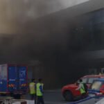 Mumbai, India: A minor fire broke out at Chhatrapati Shivaji Maharaj International Airport’s Terminal 1 in Mumbai on the evening of April 9, 2026, leading to smoke accumulation inside parts of the terminal and temporary disruption for passengers. The incident occurred around 6:10 PM and was traced to an electrical short circuit in the ground-floor utility and power distribution area near the 1B section of the terminal. According to airport and civic officials, the fire originated in electrical cable trays and power supply installations located in a restricted service zone of Terminal 1. The affected area is understood to house critical electrical infrastructure, including wiring ducts and distribution panels. The blaze did not spread beyond the utility section but generated heavy smoke, which quickly seeped into adjoining passenger areas. Thick smoke was reported across parts of the terminal building, including nearby check-in and movement zones, causing brief confusion among passengers and congestion at several points. While the fire remained confined to the technical section, visibility in some areas of the terminal was affected, prompting precautionary movement restrictions within Terminal 1. The airport’s emergency response system was activated immediately, with on-site fire and rescue teams responding first, followed by multiple units from the Mumbai Fire Brigade. Firefighting operations focused on isolating the electrical source and preventing the spread of flames through cable networks. Officials later confirmed that the fire was brought under control within minutes, while cooling and safety checks continued for several hours before the situation was fully normalised. Authorities classified the incident as a minor or Level-1 fire. Preliminary assessments indicate that the cause was a short circuit in electrical wiring and power systems. The fire was fully extinguished by around 9:20 PM, after thorough cooling operations and inspection of affected infrastructure. Despite airport authorities stating that overall flight operations remained largely unaffected and runway movements continued normally, the incident led to short-term operational impact during the evening peak period. Around 23 flights, including those operated by IndiGo, SpiceJet, Akasa Air, and Star Air, scheduled between 7 pm and 9 pm, were delayed, according to officials. The delays were mainly attributed to temporary ground handling constraints, including passenger movement, baggage processing, and gate allocation, as emergency protocols were implemented in the affected terminal area. Airport officials also confirmed that no injuries or casualties were reported. Emergency protocols ensured that passengers were kept away from affected areas, and no evacuation of the entire terminal was required. Key systems in the affected zone, including electrical supply and certain communication infrastructure, were temporarily shut down as a precaution and restored after safety clearance.