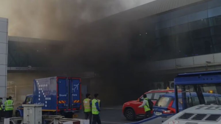 Mumbai, India: A minor fire broke out at Chhatrapati Shivaji Maharaj International Airport’s Terminal 1 in Mumbai on the evening of April 9, 2026, leading to smoke accumulation inside parts of the terminal and temporary disruption for passengers. The incident occurred around 6:10 PM and was traced to an electrical short circuit in the ground-floor utility and power distribution area near the 1B section of the terminal. According to airport and civic officials, the fire originated in electrical cable trays and power supply installations located in a restricted service zone of Terminal 1. The affected area is understood to house critical electrical infrastructure, including wiring ducts and distribution panels. The blaze did not spread beyond the utility section but generated heavy smoke, which quickly seeped into adjoining passenger areas. Thick smoke was reported across parts of the terminal building, including nearby check-in and movement zones, causing brief confusion among passengers and congestion at several points. While the fire remained confined to the technical section, visibility in some areas of the terminal was affected, prompting precautionary movement restrictions within Terminal 1. The airport’s emergency response system was activated immediately, with on-site fire and rescue teams responding first, followed by multiple units from the Mumbai Fire Brigade. Firefighting operations focused on isolating the electrical source and preventing the spread of flames through cable networks. Officials later confirmed that the fire was brought under control within minutes, while cooling and safety checks continued for several hours before the situation was fully normalised. Authorities classified the incident as a minor or Level-1 fire. Preliminary assessments indicate that the cause was a short circuit in electrical wiring and power systems. The fire was fully extinguished by around 9:20 PM, after thorough cooling operations and inspection of affected infrastructure. Despite airport authorities stating that overall flight operations remained largely unaffected and runway movements continued normally, the incident led to short-term operational impact during the evening peak period. Around 23 flights, including those operated by IndiGo, SpiceJet, Akasa Air, and Star Air, scheduled between 7 pm and 9 pm, were delayed, according to officials. The delays were mainly attributed to temporary ground handling constraints, including passenger movement, baggage processing, and gate allocation, as emergency protocols were implemented in the affected terminal area. Airport officials also confirmed that no injuries or casualties were reported. Emergency protocols ensured that passengers were kept away from affected areas, and no evacuation of the entire terminal was required. Key systems in the affected zone, including electrical supply and certain communication infrastructure, were temporarily shut down as a precaution and restored after safety clearance.