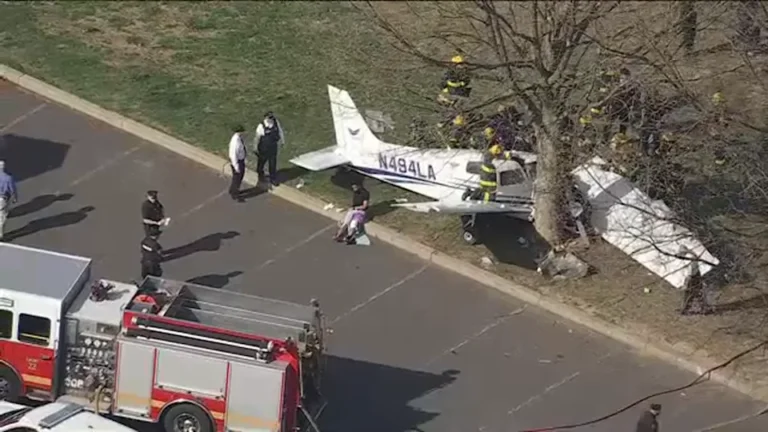 Flight Instructor And Student Injured In Northeast Philadelphia Training Flight Crash SEO DES: The aircraft operated by Fly Legacy Aviation crashed after an engine failure during a routine lesson. Both onboard survived with non-life-threatening injuries SOCIAL: A training aircraft operated by Fly Legacy Aviation crashed in Northeast Philadelphia on April 1 after an engine failure during a routine lesson, injuring an instructor and a student pilot identified as an off-duty police officer. The instructor attempted an emergency return, but the aircraft clipped a tree and crashed into Fluehr Park. Both occupants survived with non-life-threatening injuries, no one on the ground was hurt, and authorities, including the Federal Aviation Administration and National Transportation Safety Board, have launched an investigation. Philadelphia, United States: A training aircraft operated by a local flight school crashed in a residential park in Northeast Philadelphia on April 1, injuring two people onboard a flight instructor and a student pilot after an attempted emergency landing went wrong. The aircraft, identified as a Piper PA-28 (Pilot 100i), was being used for a routine instructional flight by Fly Legacy Aviation, a Philadelphia-based flight training academy. The flight had departed from Northeast Philadelphia Airport shortly before the incident. Authorities confirmed that the student pilot was the off-duty officer. Both occupants survived the crash and were transported to hospital. Officials stated they were conscious and alert, though they sustained serious but non-life-threatening injuries. Preliminary findings indicate the aircraft experienced a loss of engine power mid-flight, reportedly while flying over or near the Delaware River. The instructor initiated emergency procedures and attempted to return toward the airport. However, during the descent, the aircraft clipped a tree, lost stability and spun before crashing into Fluehr Park, a public park surrounded by residential homes. Emergency responders reached the scene quickly. Despite a minor fuel leak, no fire broke out. Authorities confirmed, no injuries on the ground and no structural damage to nearby homes Officials noted the outcome could have been significantly worse given the densely populated neighborhood surrounding the crash site. Eyewitnesses described a sudden loss of altitude before impact. One local resident told the media the aircraft appeared to be “coming down fast and struggling to stay level.” Police officials confirmed that one of the injured individuals was an off-duty officer and stated that both victims were “extremely fortunate to survive” given the nature of the crash. Emergency responders, including police and fire crews, secured the area and assisted in extraction and evacuation. The Federal Aviation Administration (FAA) and the National Transportation Safety Board (NTSB) have launched a formal investigation.