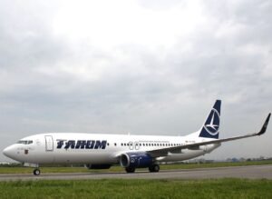 Bucharest, Romania: A serious in-flight medical emergency involving a TAROM Boeing 737 has raised renewed concerns over pilot fatigue after a co-pilot collapsed during a scheduled European service, prompting an emergency response and regulatory scrutiny. The incident occurred on April 16, 2026, during a return flight operated by Romania’s national carrier TAROM from Amsterdam Schiphol Airport to Bucharest Henri Coandă International Airport. The 57-year-old co-pilot had not slept the night before reporting for duty, a factor that investigators later identified as central to the event. The crew had earlier completed an outbound sector from Bucharest to Amsterdam, during which the co-pilot reportedly felt unwell. Despite his condition, he continued operating and joined the return flight shortly after arrival, reflecting a tight turnaround schedule. During the return leg, the co-pilot’s condition deteriorated. Reports indicate that approximately 50 minutes after departure he began feeling worse, and about 2 hours and 40 minutes into the flight, he lost consciousness in the cockpit. The captain declared an emergency and continued the flight, ensuring a safe landing in Bucharest. Medical teams were positioned on arrival and boarded the aircraft immediately to attend to the incapacitated crew member. Passengers reported to be 87 onboard were disembarked via rear stairs to allow rapid access to the cockpit. Initial findings reported that the pilot’s collapse was linked to extreme fatigue after “not sleeping a wink the night before,” reinforcing the seriousness of the situation. Romanian aviation authorities classified the occurrence as a “serious safety event,” citing the direct implications of cockpit incapacitation during flight.