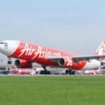 Airbus Secures Record 150 Aircraft A220 Order From AirAsia In Major Programme Boost SEO DES: The US$19B AirAsia deal pushes A220 sales beyond 1,000 aircraft, boosting Canada’s aerospace sector and Airbus’ global market strength SOCIAL: AirAsia has placed a record order for 150 Airbus A220-300 aircraft during a signing ceremony in Mirabel, Quebec, Canada, marking the largest order in A220 programme history. The Malaysian low-cost carrier also secured options for 150 future A220-500 jets, with CEO Tony Fernandes pledging support for the stretched variant if Airbus launches it. The deal pushes total A220 sales beyond 1,000 aircraft and strengthens Airbus’ position in the 100-160 seat market against Embraer. Valued at around US$19 billion, the agreement boosts Canada’s aerospace industry while supporting AirAsia’s long-term fleet expansion and fuel-efficiency strategy. Mirabel, Canada: Malaysia-based low-cost carrier AirAsia has signed a landmark agreement with Airbus for 150 Airbus A220-300 aircraft, marking the largest single order ever placed for the A220 programme and giving a major boost to the Canadian-built jetliner amid intensifying competition in the small narrowbody market. The agreement was announced during a ceremony at Airbus’ Mirabel facility in Quebec, Canada, attended by AirAsia Chief Executive Officer Tony Fernandes, Airbus Commercial Aircraft CEO Lars Wagner, and Canadian Prime Minister Mark Carney. In addition to the firm order, AirAsia secured options for another 150 aircraft tied to Airbus’ proposed stretched A220-500 variant, which has not yet been officially launched. Fernandes publicly committed to becoming the launch customer if Airbus proceeds with development of the larger model. “This plane was built to be stretched,” Fernandes told Reuters during the signing event, expressing confidence that Airbus would move ahead with the larger variant capable of seating around 180 passengers. The deal represents a major strategic win for the A220 programme, formerly known as the Bombardier CSeries before Airbus acquired control of the programme in 2018. The aircraft is assembled primarily at Airbus’ Mirabel facility in Quebec for international customers, while U.S.-bound aircraft are produced in Mobile, Alabama. Airbus said the order pushes total A220 programme sales beyond the 1,000-aircraft milestone, reinforcing the jet’s growing role in the 100- to 160-seat market segment. Industry analysts view the agreement as especially significant because the A220 programme has struggled for profitability despite growing operator acceptance worldwide. The European manufacturer has been attempting to increase A220 production rates while facing mounting competition from Brazil’s Embraer E2 family. Embraer outsold the A220 three-to-one last year and recently secured a major order campaign with Finnair. Airbus aims to raise A220 production toward 12 aircraft per month in the coming years as it works to improve programme economics. AirAsia’s order is centered on the A220-300, the larger current variant of the aircraft family. The airline will also become the launch customer for a newly certified 160-seat cabin layout featuring additional overwing emergency exits, allowing greater passenger density while maintaining the aircraft’s fuel-efficiency advantages. The airline currently operates an all-Airbus fleet and already has more than 350 A320-family aircraft on order. Fernandes indicated that a future A220-500 could eventually replace portions of AirAsia’s A320 fleet, while the group would continue focusing larger-capacity growth around the A321neo family. “If you build it, AirAsia will buy 150,” Fernandes said during the ceremony while addressing Airbus executives regarding the proposed A220-500. The proposed A220-500 has emerged as a potentially critical aircraft for Airbus as airlines increasingly seek fuel-efficient narrowbody aircraft positioned between regional jets and larger single-aisle aircraft such as the A321neo and Boeing 737 MAX family. Airbus executives said a decision on whether to proceed with the stretched variant could come later this year. Industry sources estimate the agreement’s value at approximately US$19 billion based on list prices, although aircraft transactions typically involve substantial confidential discounts. The order also delivers a major economic boost for Canada’s aerospace sector and Quebec’s government-backed investment in the programme. Quebec retains a minority stake in the A220 programme through Investissement Québec, while the Canadian federal government has also supported the programme financially since its Bombardier era. The announcement comes as airlines globally continue adjusting operations amid elevated fuel prices and supply chain disruptions linked to geopolitical tensions in the Middle East. Fernandes said AirAsia had recently reduced some flights due to rising fuel costs but expressed confidence the carrier would restore normal scheduling by July.