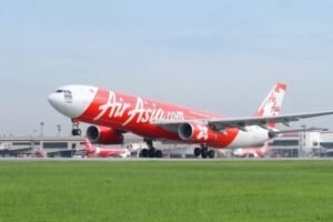 Airbus Secures Record 150 Aircraft A220 Order From AirAsia In Major Programme Boost SEO DES: The US$19B AirAsia deal pushes A220 sales beyond 1,000 aircraft, boosting Canada’s aerospace sector and Airbus’ global market strength SOCIAL: AirAsia has placed a record order for 150 Airbus A220-300 aircraft during a signing ceremony in Mirabel, Quebec, Canada, marking the largest order in A220 programme history. The Malaysian low-cost carrier also secured options for 150 future A220-500 jets, with CEO Tony Fernandes pledging support for the stretched variant if Airbus launches it. The deal pushes total A220 sales beyond 1,000 aircraft and strengthens Airbus’ position in the 100-160 seat market against Embraer. Valued at around US$19 billion, the agreement boosts Canada’s aerospace industry while supporting AirAsia’s long-term fleet expansion and fuel-efficiency strategy. Mirabel, Canada: Malaysia-based low-cost carrier AirAsia has signed a landmark agreement with Airbus for 150 Airbus A220-300 aircraft, marking the largest single order ever placed for the A220 programme and giving a major boost to the Canadian-built jetliner amid intensifying competition in the small narrowbody market. The agreement was announced during a ceremony at Airbus’ Mirabel facility in Quebec, Canada, attended by AirAsia Chief Executive Officer Tony Fernandes, Airbus Commercial Aircraft CEO Lars Wagner, and Canadian Prime Minister Mark Carney. In addition to the firm order, AirAsia secured options for another 150 aircraft tied to Airbus’ proposed stretched A220-500 variant, which has not yet been officially launched. Fernandes publicly committed to becoming the launch customer if Airbus proceeds with development of the larger model. “This plane was built to be stretched,” Fernandes told Reuters during the signing event, expressing confidence that Airbus would move ahead with the larger variant capable of seating around 180 passengers. The deal represents a major strategic win for the A220 programme, formerly known as the Bombardier CSeries before Airbus acquired control of the programme in 2018. The aircraft is assembled primarily at Airbus’ Mirabel facility in Quebec for international customers, while U.S.-bound aircraft are produced in Mobile, Alabama. Airbus said the order pushes total A220 programme sales beyond the 1,000-aircraft milestone, reinforcing the jet’s growing role in the 100- to 160-seat market segment. Industry analysts view the agreement as especially significant because the A220 programme has struggled for profitability despite growing operator acceptance worldwide. The European manufacturer has been attempting to increase A220 production rates while facing mounting competition from Brazil’s Embraer E2 family. Embraer outsold the A220 three-to-one last year and recently secured a major order campaign with Finnair. Airbus aims to raise A220 production toward 12 aircraft per month in the coming years as it works to improve programme economics. AirAsia’s order is centered on the A220-300, the larger current variant of the aircraft family. The airline will also become the launch customer for a newly certified 160-seat cabin layout featuring additional overwing emergency exits, allowing greater passenger density while maintaining the aircraft’s fuel-efficiency advantages. The airline currently operates an all-Airbus fleet and already has more than 350 A320-family aircraft on order. Fernandes indicated that a future A220-500 could eventually replace portions of AirAsia’s A320 fleet, while the group would continue focusing larger-capacity growth around the A321neo family. “If you build it, AirAsia will buy 150,” Fernandes said during the ceremony while addressing Airbus executives regarding the proposed A220-500. The proposed A220-500 has emerged as a potentially critical aircraft for Airbus as airlines increasingly seek fuel-efficient narrowbody aircraft positioned between regional jets and larger single-aisle aircraft such as the A321neo and Boeing 737 MAX family. Airbus executives said a decision on whether to proceed with the stretched variant could come later this year. Industry sources estimate the agreement’s value at approximately US$19 billion based on list prices, although aircraft transactions typically involve substantial confidential discounts. The order also delivers a major economic boost for Canada’s aerospace sector and Quebec’s government-backed investment in the programme. Quebec retains a minority stake in the A220 programme through Investissement Québec, while the Canadian federal government has also supported the programme financially since its Bombardier era. The announcement comes as airlines globally continue adjusting operations amid elevated fuel prices and supply chain disruptions linked to geopolitical tensions in the Middle East. Fernandes said AirAsia had recently reduced some flights due to rising fuel costs but expressed confidence the carrier would restore normal scheduling by July.