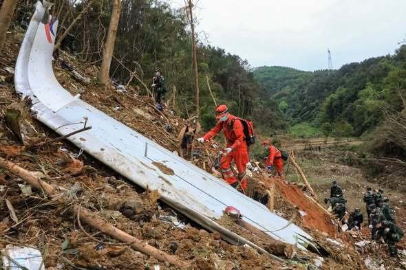 Wuzhou, China: The crash of China Eastern Airlines Flight 5735 crash continues to raise critical questions more than four years after the disaster, as newly surfaced U.S. investigative data points toward deliberate cockpit actions while Chinese authorities maintain silence, citing national security concerns. On March 21, 2022, a Boeing 737-800 operated by China Eastern Airlines plunged from cruising altitude into mountainous terrain in Guangxi, killing all 132 passengers and crew on board. The aircraft, en route from Kunming to Guangzhou, entered a near-vertical descent from approximately 29,000 feet, leaving investigators initially baffled due to the absence of distress calls or clear external triggers. Early findings released by the Civil Aviation Administration of China (CAAC) ruled out conventional causes such as mechanical failure, severe weather, or hazardous cargo. The aircraft was deemed airworthy, the crew qualified and medically fit, and no evidence of explosives was found. Flight data and cockpit voice recorders were recovered and analyzed with assistance from international agencies, including the National Transportation Safety Board (NTSB), yet interim reports issued between 2022 and 2024 stopped short of identifying a definitive cause, describing the event as “very complicated and very rare.” Attention began to shift toward possible human involvement after early assessments indicated that control inputs from the cockpit forced the aircraft into its steep descent. However, no official conclusion was publicly endorsed, and the investigation appeared to stall as updates from Chinese authorities became increasingly limited. A significant breakthrough emerged in 2026 following the release of previously undisclosed materials through a Freedom of Information Act (FOIA) request to the NTSB. According to flight data recorder analysis, both engine fuel control switches were moved to the “cutoff” position approximately 23 seconds before the recording ceased. This action resulted in an immediate loss of engine thrust, followed by autopilot disengagement and aggressive forward control inputs that drove the aircraft into a rapid descent. The loss of electrical power shortly afterward caused the recorder to stop, leaving the final moments of the flight undocumented. The cockpit voice recorder, which continued operating briefly on backup power, was successfully recovered and analyzed. However, its contents have not been made public. The NTSB confirmed that it does not retain copies of the audio, and access remains under the control of Chinese authorities, making it a crucial yet unavailable piece of evidence in determining the sequence of events inside the cockpit. While the available data suggests that the shutdown of both engines was unlikely to be accidental and is consistent with deliberate manual input, investigators have not identified which pilot may have acted or under what circumstances. The data also does not establish motive, leaving open possibilities ranging from intentional action to incapacitation or other in-flight scenarios. Reports speculating about a possible struggle in the cockpit have surfaced in some media outlets but remain unverified and are not part of any confirmed investigative findings. Despite the emergence of these critical details, the CAAC has yet to release a final accident report, well beyond the timeline prescribed under international aviation norms. Officials have indicated that disclosing further information could endanger national security or disrupt social stability, an explanation that has drawn concern from global aviation bodies and safety experts. Under standard practices, accident investigations are expected to produce a final report within one year to ensure that safety lessons are shared across the industry. The continued lack of transparency has left several fundamental questions unanswered. Without access to the cockpit voice recordings and a comprehensive official report, the exact cause of the crash remains unresolved.