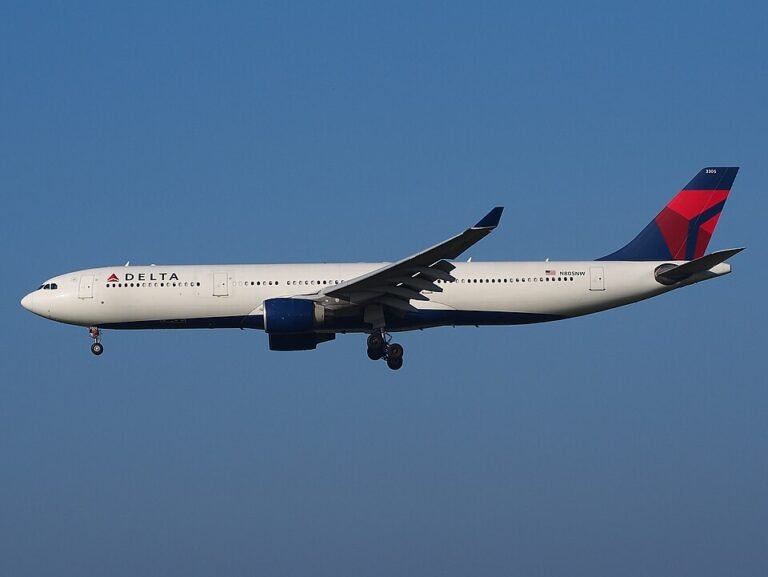 Delta Flight Makes Emergency Landing In Paris After Engine Flames And Cabin Power Loss SEO DES: Passengers heard an explosion-like sound from the left engine, saw sparks and flashes, while cabin lights briefly went dark mid-flight SOCIAL: A Delta Air Lines Airbus A330-300 flying from New York to Milan made an emergency landing in Paris after passengers heard a loud bang from the engine, saw flashes or flames outside the aircraft, and experienced a brief cabin power loss. The crew declared an emergency over France and diverted safely to Charles de Gaulle Airport, where fire and rescue teams were waiting. No injuries were reported, and the aircraft was later grounded for technical inspection following the suspected engine-related malfunction. Paris, France: A Delta Air Lines Airbus A330-300 operating a transatlantic service from New York to Milan made an emergency landing in Paris after passengers reported hearing a loud bang from one of the aircraft’s engines, followed by visible flames outside the cabin and a temporary loss of electrical power. The incident involved Delta Flight DL286, which departed John F. Kennedy International Airport on the afternoon of May 18 for a scheduled overnight flight to Milan Malpensa Airport aboard an 18-year-old Airbus A330-300. The aircraft had crossed the Atlantic normally and was cruising over French airspace early on May 19 when passengers and crew experienced what was described as a sudden “explosion-like” sound from the left engine area. Several passengers later said they observed sparks or flashes from the engine, while others reported the cabin briefly went dark as electrical power fluctuated onboard. Flight tracking data showed the aircraft abruptly altered course and declared an emergency using squawk code 7700 before diverting toward Charles de Gaulle Airport. Emergency vehicles, including airport fire and rescue crews, were positioned alongside the runway as the widebody jet approached Paris. The Airbus landed safely at CDG without further incident. No injuries among passengers or crew were immediately reported. Passengers onboard later described a tense but controlled atmosphere inside the cabin. One traveler wrote online that “the lights went out and the flight attendants booked it to the front of the plane,” while another passenger claimed people seated on the left side of the aircraft could see what appeared to be an engine fire. Others praised the crew for remaining calm and reassuring passengers throughout the diversion and landing. The aircraft involved in the incident was identified as a Delta Airbus A330-323 registered N818NW. The jet had departed JFK at approximately 4:28 PM EDT and diverted into Paris roughly six hours later after the crew declared the emergency over France. While the exact technical cause has not yet been officially confirmed, early reports indicate the crew responded to an engine-related malfunction accompanied by an electrical disturbance affecting cabin systems. Following the landing, the aircraft was removed from service for inspection by maintenance personnel and aviation authorities. Delta Air Lines had not released a detailed technical statement at the time of publication.