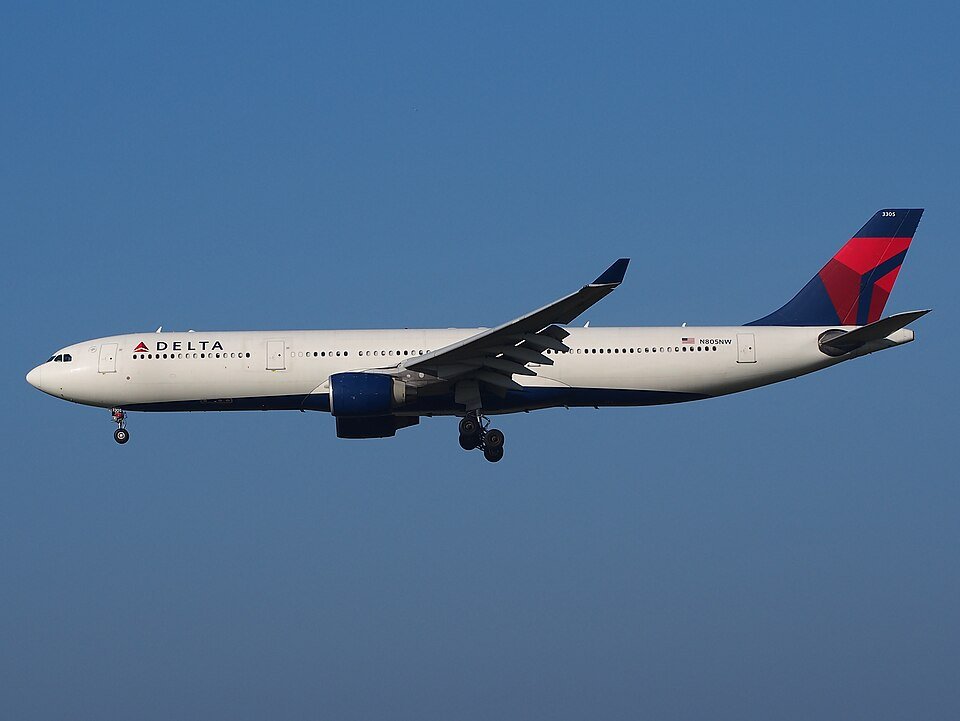 Delta Flight Makes Emergency Landing In Paris After Engine Flames And Cabin Power Loss SEO DES: Passengers heard an explosion-like sound from the left engine, saw sparks and flashes, while cabin lights briefly went dark mid-flight SOCIAL: A Delta Air Lines Airbus A330-300 flying from New York to Milan made an emergency landing in Paris after passengers heard a loud bang from the engine, saw flashes or flames outside the aircraft, and experienced a brief cabin power loss. The crew declared an emergency over France and diverted safely to Charles de Gaulle Airport, where fire and rescue teams were waiting. No injuries were reported, and the aircraft was later grounded for technical inspection following the suspected engine-related malfunction. Paris, France: A Delta Air Lines Airbus A330-300 operating a transatlantic service from New York to Milan made an emergency landing in Paris after passengers reported hearing a loud bang from one of the aircraft’s engines, followed by visible flames outside the cabin and a temporary loss of electrical power. The incident involved Delta Flight DL286, which departed John F. Kennedy International Airport on the afternoon of May 18 for a scheduled overnight flight to Milan Malpensa Airport aboard an 18-year-old Airbus A330-300. The aircraft had crossed the Atlantic normally and was cruising over French airspace early on May 19 when passengers and crew experienced what was described as a sudden “explosion-like” sound from the left engine area. Several passengers later said they observed sparks or flashes from the engine, while others reported the cabin briefly went dark as electrical power fluctuated onboard. Flight tracking data showed the aircraft abruptly altered course and declared an emergency using squawk code 7700 before diverting toward Charles de Gaulle Airport. Emergency vehicles, including airport fire and rescue crews, were positioned alongside the runway as the widebody jet approached Paris. The Airbus landed safely at CDG without further incident. No injuries among passengers or crew were immediately reported. Passengers onboard later described a tense but controlled atmosphere inside the cabin. One traveler wrote online that “the lights went out and the flight attendants booked it to the front of the plane,” while another passenger claimed people seated on the left side of the aircraft could see what appeared to be an engine fire. Others praised the crew for remaining calm and reassuring passengers throughout the diversion and landing. The aircraft involved in the incident was identified as a Delta Airbus A330-323 registered N818NW. The jet had departed JFK at approximately 4:28 PM EDT and diverted into Paris roughly six hours later after the crew declared the emergency over France. While the exact technical cause has not yet been officially confirmed, early reports indicate the crew responded to an engine-related malfunction accompanied by an electrical disturbance affecting cabin systems. Following the landing, the aircraft was removed from service for inspection by maintenance personnel and aviation authorities. Delta Air Lines had not released a detailed technical statement at the time of publication.