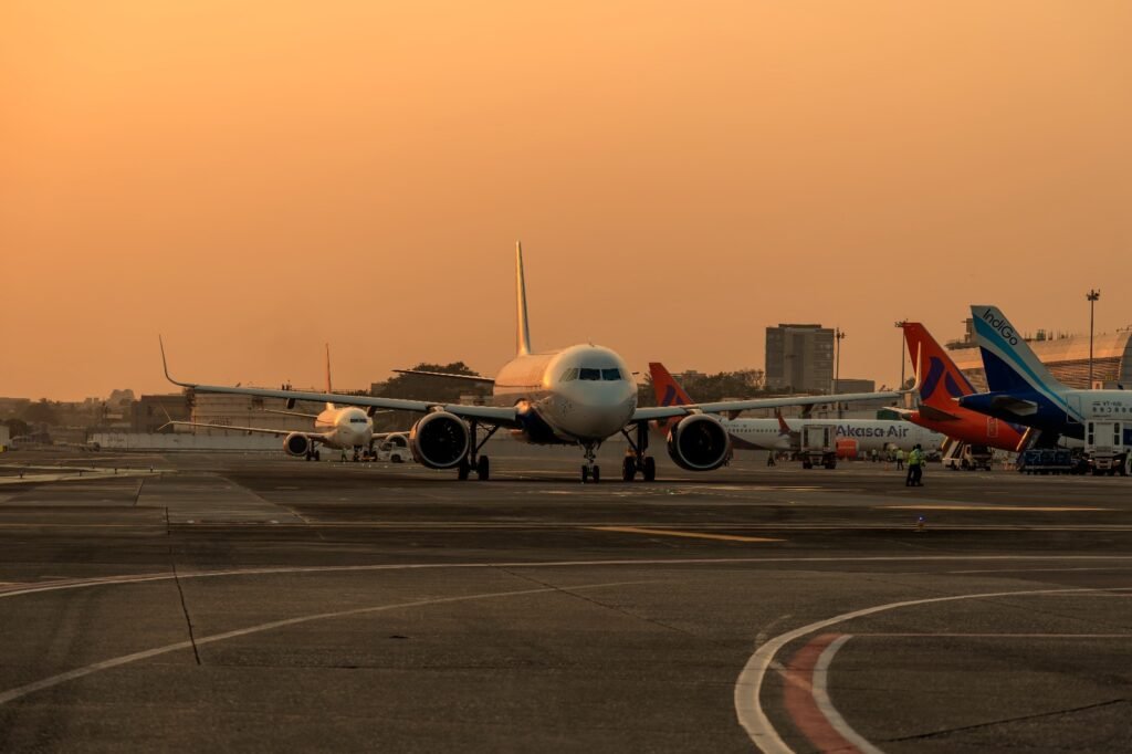 New Delhi, India: The Union Cabinet has approved a dedicated ₹5,000 crore emergency credit support window for Indian airlines under the Emergency Credit Line Guarantee Scheme (ECLGS) 5.0, as carriers grapple with mounting operational and financial pressure arising from the ongoing West Asia crisis. According to the official release issued by the Press Information Bureau (PIB) and the Ministry of Civil Aviation, Indian airlines have come under severe financial stress following a sharp surge in Aviation Turbine Fuel (ATF) prices, airspace restrictions and operational disruptions linked to the geopolitical situation in West Asia. The government said international operations have been particularly affected due to rerouted flight paths, longer flying times, lower aircraft utilisation and increased operating expenses, resulting in short-term liquidity mismatches for carriers. Under ECLGS 5.0, scheduled passenger airlines will be eligible for additional emergency credit support of up to 100% of their peak working capital utilisation during the fourth quarter of FY2025-26, subject to a cap of ₹1,500 crore per borrower. The loans sanctioned under the scheme will carry a seven-year tenure, including a two-year moratorium on principal repayment. The scheme will provide a 90% government guarantee cover on loans extended to airlines and non-MSME borrowers through the National Credit Guarantee Trustee Company Limited (NCGTC), while MSMEs will receive 100% guarantee coverage. The Cabinet said the move is intended to ensure continuity of operations, protect jobs, stabilise supply chains and maintain domestic economic activity amid rising geopolitical uncertainty and elevated crude oil prices. Eligible borrowers under the scheme include MSMEs, non-MSMEs with existing working capital limits and scheduled passenger airlines with outstanding credit facilities as of March 31, 2026, provided their accounts remain standard and non-performing assets are excluded. For MSMEs and other eligible businesses, additional borrowing will be capped at 20% of peak working capital utilisation during Q4 FY26, subject to a maximum of ₹100 crore. These loans will carry a five-year tenure with a one-year moratorium. The government has also waived guarantee fees under the scheme in a bid to accelerate credit flow and encourage banks and financial institutions to lend despite heightened risk conditions. The ECLGS 5.0 facility will remain open for sanctions until March 31, 2027. Information and Broadcasting Minister Ashwini Vaishnaw said the scheme was designed to provide immediate liquidity relief to sectors directly affected by the West Asia conflict and to prevent disruptions to industrial activity and employment. CAPA India described the measure as a major relief for the sector, noting that the government had already taken steps to secure ATF supplies and reduce operational costs before extending direct credit support. Market reaction remained positive following the announcement. Shares of InterGlobe Aviation, parent company of IndiGo, and SpiceJet gained after investors responded favourably to the liquidity support package. The latest ECLGS iteration marks the fifth version of the emergency credit programme originally introduced during the COVID-19 pandemic under the Atmanirbhar Bharat initiative to provide collateral-free, government-backed loans to stressed businesses. While industry bodies welcomed the move, some economists and market observers cautioned that extended moratoriums and large-scale guaranteed lending could create future repayment and credit discipline risks if geopolitical instability persists longer than expected. The announcement comes as India faces broader economic risks from volatile global oil prices, trade disruptions and reduced regional aviation efficiency linked to the escalating conflict in West Asia.