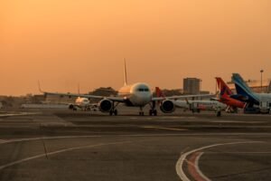 Mirabel, Canada: Malaysia-based low-cost carrier AirAsia has signed a landmark agreement with Airbus for 150 Airbus A220-300 aircraft, marking the largest single order ever placed for the A220 programme and giving a major boost to the Canadian-built jetliner amid intensifying competition in the small narrowbody market. The agreement was announced during a ceremony at Airbus’ Mirabel facility in Quebec, Canada, attended by AirAsia Chief Executive Officer Tony Fernandes, Airbus Commercial Aircraft CEO Lars Wagner, and Canadian Prime Minister Mark Carney. In addition to the firm order, AirAsia secured options for another 150 aircraft tied to Airbus’ proposed stretched A220-500 variant, which has not yet been officially launched. Fernandes publicly committed to becoming the launch customer if Airbus proceeds with development of the larger model. “This plane was built to be stretched,” Fernandes told Reuters during the signing event, expressing confidence that Airbus would move ahead with the larger variant capable of seating around 180 passengers. The deal represents a major strategic win for the A220 programme, formerly known as the Bombardier CSeries before Airbus acquired control of the programme in 2018. The aircraft is assembled primarily at Airbus’ Mirabel facility in Quebec for international customers, while U.S.-bound aircraft are produced in Mobile, Alabama. Airbus said the order pushes total A220 programme sales beyond the 1,000-aircraft milestone, reinforcing the jet’s growing role in the 100- to 160-seat market segment. Industry analysts view the agreement as especially significant because the A220 programme has struggled for profitability despite growing operator acceptance worldwide. The European manufacturer has been attempting to increase A220 production rates while facing mounting competition from Brazil’s Embraer E2 family. Embraer outsold the A220 three-to-one last year and recently secured a major order campaign with Finnair. Airbus aims to raise A220 production toward 12 aircraft per month in the coming years as it works to improve programme economics. AirAsia’s order is centered on the A220-300, the larger current variant of the aircraft family. The airline will also become the launch customer for a newly certified 160-seat cabin layout featuring additional overwing emergency exits, allowing greater passenger density while maintaining the aircraft’s fuel-efficiency advantages. The airline currently operates an all-Airbus fleet and already has more than 350 A320-family aircraft on order. Fernandes indicated that a future A220-500 could eventually replace portions of AirAsia’s A320 fleet, while the group would continue focusing larger-capacity growth around the A321neo family. “If you build it, AirAsia will buy 150,” Fernandes said during the ceremony while addressing Airbus executives regarding the proposed A220-500. The proposed A220-500 has emerged as a potentially critical aircraft for Airbus as airlines increasingly seek fuel-efficient narrowbody aircraft positioned between regional jets and larger single-aisle aircraft such as the A321neo and Boeing 737 MAX family. Airbus executives said a decision on whether to proceed with the stretched variant could come later this year. Industry sources estimate the agreement’s value at approximately US$19 billion based on list prices, although aircraft transactions typically involve substantial confidential discounts. The order also delivers a major economic boost for Canada’s aerospace sector and Quebec’s government-backed investment in the programme. Quebec retains a minority stake in the A220 programme through Investissement Québec, while the Canadian federal government has also supported the programme financially since its Bombardier era. The announcement comes as airlines globally continue adjusting operations amid elevated fuel prices and supply chain disruptions linked to geopolitical tensions in the Middle East. Fernandes said AirAsia had recently reduced some flights due to rising fuel costs but expressed confidence the carrier would restore normal scheduling by July.