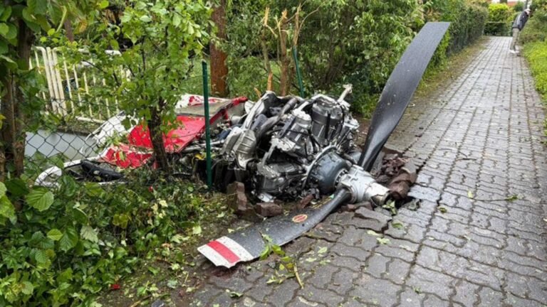 Limburgerhof, Germany: Two people were killed after a small aircraft crashed into a residential neighborhood in the German municipality of Limburgerhof in Rhineland-Palatinate on May 16, authorities and local media confirmed. The crash occurred at around 11:30 a.m. local time near Max-Planck-Straße on the outskirts of Limburgerhof, a town south of Mannheim with a population of about 11,600 residents. Police said the aircraft went down on a residential property, scattering debris across houses, garages, gardens, pathways and nearby streets over a wide area. According to police spokesperson Thorsten Mischler, both occupants of the aircraft died in the crash. Authorities later confirmed the victims were male. Initial police statements said there were no confirmed injuries among residents on the ground, although German outlet Welt reported that a 66-year-old woman was slightly injured after falling while trying to escape from falling debris. Witnesses described hearing a loud bang or explosion moments before the aircraft came down. Several eyewitnesses told investigators the plane appeared to explode in mid-air before crashing into the residential area. Reports also stated the aircraft may have clipped or grazed a house during its descent. Parts of the wreckage became lodged in fences while other debris landed in front of homes and across surrounding properties. The main section of the aircraft reportedly came to rest in the garden of a residential house. Police and emergency responders launched a major operation immediately after the crash. Authorities established a large security perimeter around the site while investigators documented debris locations and examined the wreckage. A police helicopter was deployed shortly after noon to capture aerial photographs of the accident scene as part of the investigation. Investigators said the aircraft had departed earlier in the day from Aachen in western Germany. However, officials stated that both the planned route and intended destination of the flight remain under investigation. The exact cause of the crash has not yet been determined. Authorities also appealed to residents and property owners in the area to report any additional debris or footage connected to the incident. Police requested that discovered wreckage pieces be left untouched until they could be officially documented and collected by investigators. A temporary support and information center for affected residents and witnesses was established at the Albert-Schweitzer-Haus in Limburgerhof.