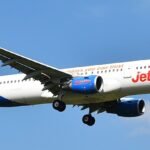Porto, Portugal: A Jet2 passenger flight travelling from Tenerife, Spain, to Birmingham, United Kingdom, was forced to make an emergency diversion to Portugal after one of the pilots suffered a serious medical emergency while the aircraft was cruising at approximately 30,000 feet. The incident involved Jet2 Flight LS1266, operated by an Airbus A321, carrying around 220 passengers and crew. The aircraft departed Tenerife late on May 21 and was en route to Birmingham when the cockpit emergency unfolded during the early hours of May 22. Several passengers later described scenes of panic onboard after the cabin crew suddenly rushed through the cabin asking whether any doctors or medically trained passengers were onboard. According to passengers flashing cabin lights and the rapid descent of the aircraft woke sleeping travellers. Families travelling with children described distress inside the cabin, with several passengers reporting that crying babies and panic among travellers added to the tense atmosphere during the emergency diversion. Some passengers alleged that cabin crew appeared visibly distressed while attempting to assist the incapacitated pilot. The First Officer reportedly took immediate control of the aircraft after the captain became incapacitated. The Airbus A321 then diverted toward Porto’s Francisco Sá Carneiro Airport, where emergency medical teams were already positioned on the runway before landing. The aircraft touched down safely at approximately 2:11 a.m. local time. Medical responders boarded the aircraft immediately after arrival and transported the affected pilot to a nearby hospital for treatment. While several passenger accounts stated that the pilot suffered a heart attack, Jet2 has not officially confirmed the exact medical condition. The airline only stated that one of the pilots became “unwell” during the flight and emphasized that “at no point was safety compromised.” Passengers were reportedly left stranded in Portugal for more than 13 hours following the emergency landing. Some travellers complained about delays in disembarkation, lack of immediate accommodation and limited communication regarding onward travel arrangements. Jet2 later dispatched a replacement pilot from Manchester to continue the journey to Birmingham.