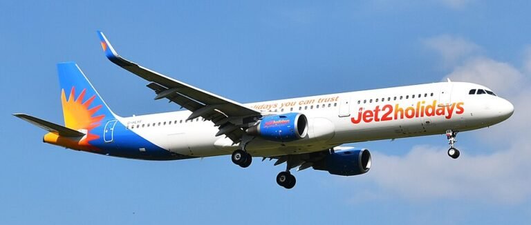 Porto, Portugal: A Jet2 passenger flight travelling from Tenerife, Spain, to Birmingham, United Kingdom, was forced to make an emergency diversion to Portugal after one of the pilots suffered a serious medical emergency while the aircraft was cruising at approximately 30,000 feet. The incident involved Jet2 Flight LS1266, operated by an Airbus A321, carrying around 220 passengers and crew. The aircraft departed Tenerife late on May 21 and was en route to Birmingham when the cockpit emergency unfolded during the early hours of May 22. Several passengers later described scenes of panic onboard after the cabin crew suddenly rushed through the cabin asking whether any doctors or medically trained passengers were onboard. According to passengers flashing cabin lights and the rapid descent of the aircraft woke sleeping travellers. Families travelling with children described distress inside the cabin, with several passengers reporting that crying babies and panic among travellers added to the tense atmosphere during the emergency diversion. Some passengers alleged that cabin crew appeared visibly distressed while attempting to assist the incapacitated pilot. The First Officer reportedly took immediate control of the aircraft after the captain became incapacitated. The Airbus A321 then diverted toward Porto’s Francisco Sá Carneiro Airport, where emergency medical teams were already positioned on the runway before landing. The aircraft touched down safely at approximately 2:11 a.m. local time. Medical responders boarded the aircraft immediately after arrival and transported the affected pilot to a nearby hospital for treatment. While several passenger accounts stated that the pilot suffered a heart attack, Jet2 has not officially confirmed the exact medical condition. The airline only stated that one of the pilots became “unwell” during the flight and emphasized that “at no point was safety compromised.” Passengers were reportedly left stranded in Portugal for more than 13 hours following the emergency landing. Some travellers complained about delays in disembarkation, lack of immediate accommodation and limited communication regarding onward travel arrangements. Jet2 later dispatched a replacement pilot from Manchester to continue the journey to Birmingham.