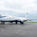 Abuja, Nigeria: Nigeria’s domestic aviation sector has entered a fresh regulatory dispute after the Nigerian Civil Aviation Authority (NCAA) placed 11 airlines on a “No-Pay-No-Service” list over alleged unpaid statutory obligations, prompting strong denials from airline operators and raising concerns over potential operational disruptions across the country. The directive, contained in an internal NCAA memo dated May 22, 2026, instructed all directorates and regional offices of the regulator not to provide services to affected airlines without clearance from the Directorate of Finance and Accounts. The memo was signed by Olufemi Odukoya, NCAA’s Director of Finance and Accounts, and copied to the Director-General of Civil Aviation (DGCA), Capt. Chris Najomo, along with senior officials within the authority. The airlines named in the updated “No-Pay-No-Service” list are: Air Peace Ibom Air Arik Air United Nigeria Airlines Umza Air NG Eagle Max Air Caverton Helicopters Overland Airways Rano Air ValueJet According to the memo, “no directorate should render any service to the above airlines without financial clearance from the Director of Finance and Accounts.” The NCAA argued that the move was necessary because airlines had failed to meet outstanding financial obligations owed to the regulator. At the center of the dispute are the statutory five percent Ticket Sales Charge (TSC) and Cargo Sales Charge (CSC), levies collected by airlines on behalf of the NCAA from passengers and cargo operators. The regulator relies heavily on these remittances to fund safety oversight, inspections, personnel obligations, economic regulation and other administrative responsibilities within Nigeria’s aviation sector. However, the Airline Operators of Nigeria (AON), representing domestic carriers, rejected the allegations and described reports suggesting airlines were indebted to the NCAA as inaccurate. According to the operators, many NCAA services are already paid for in advance under a “cash-before-service” arrangement, making the regulator’s characterization misleading. The airlines reportedly argued that the disputed amounts relate mainly to the Ticket Sales Charge collection system rather than direct service debts. Industry operators also renewed calls for reforms to Nigeria’s aviation charging structure, urging the government to amend regulations so the NCAA can collect the five percent TSC directly from passengers instead of routing collections through airlines. Carriers argue that the current system exposes them to banking charges, reconciliation complications and financial pressure amid rising operational costs. The latest dispute comes during a difficult financial period for Nigerian airlines, which continue to face mounting economic challenges driven by soaring Jet A1 fuel prices, foreign exchange shortages, high maintenance expenses, airport charges and weak profit margins. In April 2026, domestic carriers had warned of possible operational shutdowns due to escalating fuel costs and debt burdens. Following negotiations with airline operators, Nigerian President Bola Tinubu approved, in principle, a 30 percent reduction or write-off of debts owed by airlines to aviation agencies as part of broader relief measures aimed at stabilizing the sector. The ICIR reported that Tinubu approved the debt relief initiative on April 23, 2026, though implementation had not commenced as of late May. Explaining the delay, NCAA Director-General Capt. Chris Najomo stated that the process required consultations with airlines and aviation agencies before execution. Another aviation consultant, Adeola Fadairo, defended the NCAA’s action, arguing that the Ticket Sales Charge belongs to the regulator and should not be retained by airlines to offset operational shortfalls. He described non-remittance of statutory levies as a serious breach of public trust and corporate responsibility. Meanwhile, United Nigeria Airlines confirmed it had opened discussions with the NCAA regarding the matter, while several other affected airlines had not publicly commented at the time of reporting. However, the NCAA later suspended enforcement of the “No-Pay-No-Service” directive following industry backlash and concerns that the move could disrupt airline operations, licensing processes and other regulatory services. The regulator said the temporary relief would allow further consultations with airlines and aviation stakeholders over the disputed Ticket Sales Charges and outstanding obligations.