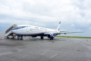 Abuja, Nigeria: Nigeria’s domestic aviation sector has entered a fresh regulatory dispute after the Nigerian Civil Aviation Authority (NCAA) placed 11 airlines on a “No-Pay-No-Service” list over alleged unpaid statutory obligations, prompting strong denials from airline operators and raising concerns over potential operational disruptions across the country. The directive, contained in an internal NCAA memo dated May 22, 2026, instructed all directorates and regional offices of the regulator not to provide services to affected airlines without clearance from the Directorate of Finance and Accounts. The memo was signed by Olufemi Odukoya, NCAA’s Director of Finance and Accounts, and copied to the Director-General of Civil Aviation (DGCA), Capt. Chris Najomo, along with senior officials within the authority. The airlines named in the updated “No-Pay-No-Service” list are: Air Peace Ibom Air Arik Air United Nigeria Airlines Umza Air NG Eagle Max Air Caverton Helicopters Overland Airways Rano Air ValueJet According to the memo, “no directorate should render any service to the above airlines without financial clearance from the Director of Finance and Accounts.” The NCAA argued that the move was necessary because airlines had failed to meet outstanding financial obligations owed to the regulator. At the center of the dispute are the statutory five percent Ticket Sales Charge (TSC) and Cargo Sales Charge (CSC), levies collected by airlines on behalf of the NCAA from passengers and cargo operators. The regulator relies heavily on these remittances to fund safety oversight, inspections, personnel obligations, economic regulation and other administrative responsibilities within Nigeria’s aviation sector. However, the Airline Operators of Nigeria (AON), representing domestic carriers, rejected the allegations and described reports suggesting airlines were indebted to the NCAA as inaccurate. According to the operators, many NCAA services are already paid for in advance under a “cash-before-service” arrangement, making the regulator’s characterization misleading. The airlines reportedly argued that the disputed amounts relate mainly to the Ticket Sales Charge collection system rather than direct service debts. Industry operators also renewed calls for reforms to Nigeria’s aviation charging structure, urging the government to amend regulations so the NCAA can collect the five percent TSC directly from passengers instead of routing collections through airlines. Carriers argue that the current system exposes them to banking charges, reconciliation complications and financial pressure amid rising operational costs. The latest dispute comes during a difficult financial period for Nigerian airlines, which continue to face mounting economic challenges driven by soaring Jet A1 fuel prices, foreign exchange shortages, high maintenance expenses, airport charges and weak profit margins. In April 2026, domestic carriers had warned of possible operational shutdowns due to escalating fuel costs and debt burdens. Following negotiations with airline operators, Nigerian President Bola Tinubu approved, in principle, a 30 percent reduction or write-off of debts owed by airlines to aviation agencies as part of broader relief measures aimed at stabilizing the sector. The ICIR reported that Tinubu approved the debt relief initiative on April 23, 2026, though implementation had not commenced as of late May. Explaining the delay, NCAA Director-General Capt. Chris Najomo stated that the process required consultations with airlines and aviation agencies before execution. Another aviation consultant, Adeola Fadairo, defended the NCAA’s action, arguing that the Ticket Sales Charge belongs to the regulator and should not be retained by airlines to offset operational shortfalls. He described non-remittance of statutory levies as a serious breach of public trust and corporate responsibility. Meanwhile, United Nigeria Airlines confirmed it had opened discussions with the NCAA regarding the matter, while several other affected airlines had not publicly commented at the time of reporting. However, the NCAA later suspended enforcement of the “No-Pay-No-Service” directive following industry backlash and concerns that the move could disrupt airline operations, licensing processes and other regulatory services. The regulator said the temporary relief would allow further consultations with airlines and aviation stakeholders over the disputed Ticket Sales Charges and outstanding obligations.