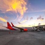 Two Pilot Deaths In 48 Hours Trigger Alarm Over Fatigue Crisis In Indian Aviation SEO DES: ALPA flagged relaxed implementation of FDTL norms, underreported fatigue and long hours working up to 60 weekly; despite DGCA efforts, gaps persist SOCIAL: Two pilot deaths within 48 hours have intensified concerns over fatigue in Indian aviation, with the Airline Pilots’ Association of India warning that delays in stricter duty-time rules could threaten safety. Both pilots were under 45, medically cleared, and operating within current limits, raising doubts about the adequacy of existing regulations. ALPA highlighted systemic issues including relaxed implementation of FDTL norms, underreporting of fatigue, and demanding schedules, with pilots working up to 60 hours a week. Despite regulatory efforts by the Directorate General of Civil Aviation, enforcement gaps persist. The association has called for immediate implementation of revised fatigue rules, stressing that pilot fatigue is a critical flight safety risk amid India’s rapidly growing aviation sector. New Delhi, India: The deaths of two commercial pilots within a span of 48 hours have prompted the Airline Pilots’ Association of India (ALPA) to raise urgent concerns over pilot fatigue, warning that delays in implementing stricter duty-time regulations could pose a serious threat to flight safety. In a formal communication to the Directorate General of Civil Aviation (DGCA) on May 1, 2026, ALPA stated that both pilots died “in the line of duty,” intensifying scrutiny of working conditions in India’s rapidly expanding aviation sector. According to reports, one of the deceased was an Air India pilot who died during a layover in Bali, while the other, an Akasa Air pilot, died in Bengaluru during training. Both were under 45 years of age, had cleared mandatory medical checks, and were operating within existing DGCA duty limits. The circumstances have raised critical questions about whether compliance with current regulations is sufficient to ensure pilot health and operational safety. ALPA warned that repeated delays and relaxations in implementing revised Flight Duty Time Limitations (FDTL) are exacerbating fatigue among pilots. The association said that temporary exemptions granted to airlines have effectively become routine, weakening the intent of fatigue management rules. The body also highlighted concerns over what it described as an “alarmingly low” acceptance rate of fatigue reports submitted by pilots, suggesting systemic discouragement of reporting within airlines. Parallel reporting indicates that ALPA has cautioned that postponing full implementation of court-mandated FDTL norms could undermine safety protocols and worsen fatigue-related risks. Data cited in investigative findings show that Indian pilots can be scheduled for up to 60 hours of duty per week exceeding internationally recognised thresholds linked to increased cardiovascular risk. The report also noted a rise in pilots declared medically unfit over the years, alongside multiple instances of relatively young pilots suffering cardiac events while on duty or shortly after flights. Industry data further suggests inconsistencies in fatigue reporting. For instance, some airlines report significantly fewer fatigue incidents despite operating more demanding long-haul schedules, raising questions about reporting practices and safety culture. Pilot fatigue has been a persistent issue in Indian aviation. Previous incidents including deaths of on-duty pilots and widespread complaints about demanding rosters have repeatedly triggered calls for reform. Regulatory action has been attempted in recent years. The DGCA introduced stricter fatigue management rules, including increased weekly rest periods and limits on night operations. However, implementation has been uneven, with temporary relaxations granted to airlines to maintain operational stability. The issue came into sharper focus during the 2025 IndiGo scheduling crisis, when disruptions exposed structural weaknesses in crew planning and fatigue management across the sector. ALPA has urged the DGCA to fully implement revised fatigue regulations without further delay, ensure transparency in fatigue data, and strengthen protections for pilots reporting exhaustion. The association maintains that addressing fatigue is not merely a labour issue but a critical safety imperative, particularly as India continues to witness rapid growth in air traffic and fleet expansion.