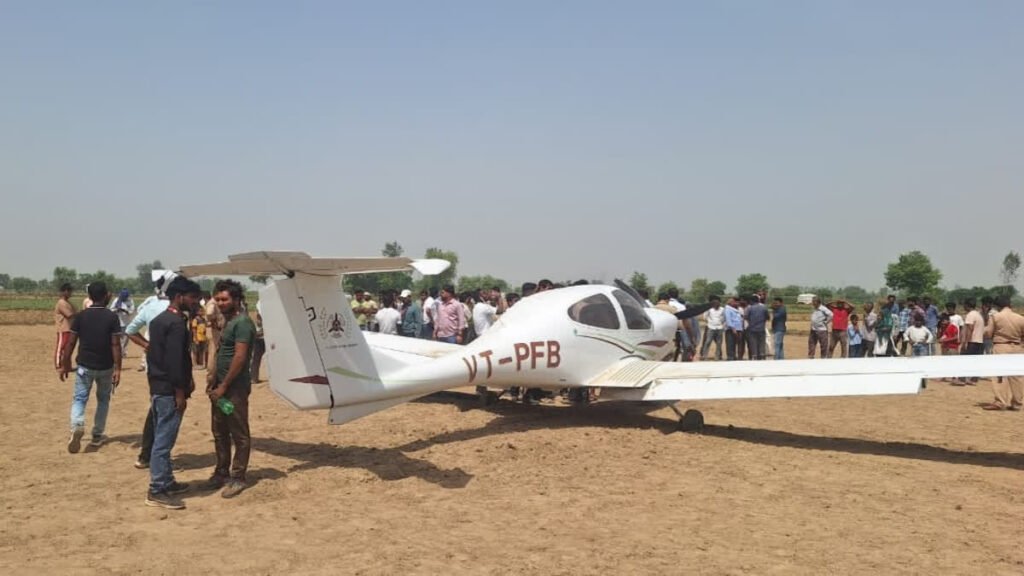 Aligarh, India: A training aircraft belonging to a private flying club made an emergency landing in an agricultural field in Uttar Pradesh’s Aligarh district on Sunday after suffering a technical malfunction during a routine training sortie, with both occupants escaping safely, according to the officials and PTI . The aircraft involved in the incident was identified as a Diamond DA-40, a single-engine, four-seater trainer aircraft bearing registration VT-PFB, which was operating from Dhanipur Airport in Aligarh when the crew reported a mid-air technical snag prompting the pilots to carry out a precautionary landing in a field near Changeyri (also reported as Changari) village under the Harduaganj police station area. Officials said the aircraft belonged to the Pioneer Flying Club, one of the pilot training organisations operating from Dhanipur Airport. The incident occurred during a scheduled training exercise on Sunday morning, with reports placing the emergency landing between approximately 9:30 am and 11 am. The instructor pilot and trainee pilot safely exited the aircraft after the landing and did not suffer injuries. Both were later taken to a district hospital for routine medical examination. Eyewitnesses said panic spread among villagers after they saw the aircraft descending suddenly towards the ground. However, the plane landed safely in the field without causing any damage or injuries. Following the incident, local police, fire brigade personnel and district administration officials rushed to the spot. City Magistrate Atul Gupta and Airport Director Satyavrat also inspected the site. Authorities said the pilots managed to bring the aircraft down safely in the agricultural field without causing casualties or significant structural damage to the aircraft. The successful emergency handling prevented what officials described as a potentially serious accident. City Magistrate Atul Gupta confirmed that airport authorities were informed shortly after the incident and emergency response teams were dispatched to the site. Officials from the Airports Authority of India (AAI) subsequently initiated a probe into the technical malfunction and circumstances leading to the forced landing. Last year, a trainee pilot from Pioneer Flying Club crashed a solo-operated Diamond DA-40 trainer aircraft at Aligarh’s Dhanipur Airstrip after the aircraft reportedly skidded off the runway during landing and slammed into the airport boundary wall. The May 2025 incident occurred during a routine solo training sortie, with trainee pilot escaping unhurt despite the aircraft sustaining heavy damage to its nose and front landing gear. Also, in January 2022, a Cessna 172 aircraft from the same academy made an emergency landing in an agricultural field near Dhanipur airstrip during a night cross-country training session. Both the instructor and trainee pilot survived with minor injuries.