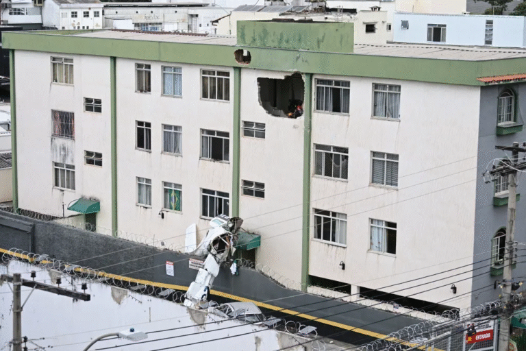 Belo Horizonte, Brazil: A small twin-engine aircraft crashed into a residential building in the Silveira neighbourhood of Belo Horizonte on Monday, killing three of the five people onboard and injuring two others, according to Brazilian authorities. The aircraft, identified as an Embraer EMB-721C, departed from Pampulha Airport at approximately 12:16 p.m. local time, bound for São Paulo. Within minutes of takeoff, the aircraft began experiencing difficulties and remained airborne for only a short duration before losing altitude. It ultimately crashed around 12:25 p.m. into a three-storey residential building, striking a stairwell area between floors, which helped prevent casualties among residents. Authorities confirmed that three occupants died in the crash. The victims include pilot Wellington Oliveira and passenger Fernando Moreira Souto, who was the son of the mayor of Jequitinhonha. Souto was initially rescued in critical condition but later succumbed to his injuries in hospital. The co-pilot also died, though their identity has not been officially released in primary reports. Two other passengers survived the crash and were taken to hospital, where they are reported to be in stable condition. Eyewitness accounts and initial footage indicate that the aircraft appeared to be circling and descending abnormally before impact, suggesting a possible loss of power or control shortly after departure. Despite the direct collision with the building, no residents on the ground were injured, and structural damage was limited, avoiding a potentially larger disaster. Emergency responders, including firefighters, medical teams and civil defence personnel, reached the crash site within minutes. Residents of the building were evacuated as a precaution while authorities secured the area and assisted survivors. The cause of the crash remains under investigation. Brazil’s Aeronautical Accidents Investigation and Prevention Center (CENIPA), along with regional unit SERIPA III and the Civil Police of Minas Gerais, have launched a formal probe. Investigators are examining possible mechanical issues, operational factors and the aircraft’s condition. In response to the incident, officials in Jequitinhonha declared three days of mourning following the death of Fernando Moreira Souto. Authorities have not yet released a final determination on what led to the crash, and investigations are ongoing.
