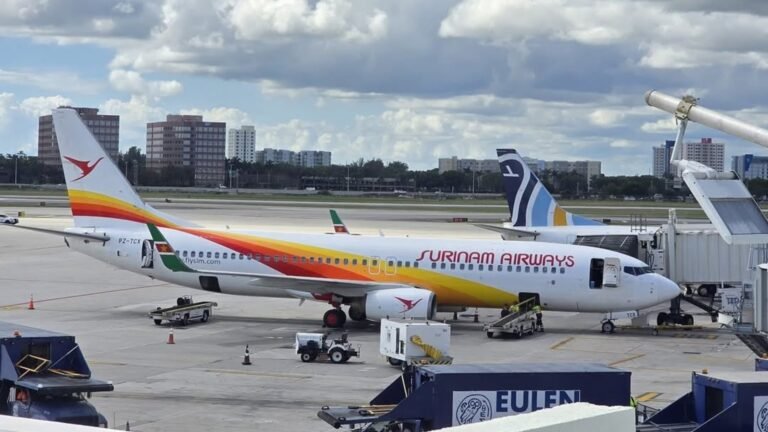Amsterdam, Netherlands: A Surinam Airways flight from Amsterdam to Paramaribo suffered a landing gear door malfunction on May 8, creating significant aerodynamic drag and increased fuel burn that forced the aircraft to return to Amsterdam as a precaution. The flight was being operated by Universal Sky Carrier under a wet-lease arrangement using a former Lufthansa Airbus A340-600. After identifying the issue, the crew opted to discontinue the flight and initiated a precautionary return to Schiphol. The aircraft reportedly remained airborne for some time to manage fuel levels before safely landing back in Amsterdam without further incident. No injuries among passengers or crew were reported. Emergency services were positioned as a standard precaution during the aircraft’s return. The disruption resulted in a delay to the Amsterdam-Paramaribo service as the aircraft required technical inspection following landing. The mandatory crew rest requirements and maintenance checks led to the flight being rescheduled for departure on May 10. The incident comes as Surinam Airways continues relying on Airbus A340 aircraft for its long-haul Amsterdam operations amid ongoing fleet and operational challenges. The carrier has operated multiple leased A340 variants over recent years, including aircraft previously sourced from Air Belgium and other operators for the Paramaribo route. The airline has faced earlier operational disruptions involving Airbus A340 aircraft, including flap-related return incidents and temporary aircraft groundings on the Amsterdam sector. While no official technical statement has yet been released detailing the exact cause of the landing gear door malfunction, the aircraft landed safely and no damage or injuries were reported.