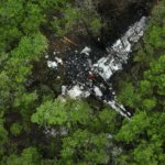 Hays County, United States: A late-night aviation tragedy in Texas Hill Country has left five people dead after a twin-engine aircraft crashed near Wimberley in Hays County on April 30, 2026. According to local authorities and federal officials, the aircraft identified as a Cessna 421C went down at approximately 11:00 p.m. in a wooded area off Round Rock Road, triggering an immediate emergency response from fire and rescue crews. All five occupants onboard, including the pilot and four passengers, were pronounced dead at the scene. Flight tracking data indicates the aircraft was traveling from Amarillo to New Braunfels when it encountered trouble during the latter phase of the journey. Data shows the aircraft made a sudden sharp turn before entering a rapid descent, dropping from approximately 13,600 feet to around 7,000 feet within a short span. Radar contact was lost shortly thereafter. Officials said the aircraft impacted the ground at a high rate of speed, suggesting a catastrophic loss of control prior to the crash. Residents in the area reported hearing a loud explosion-like sound, followed by vibrations and visible flames. Several described seeing a fireball at the crash site moments after impact. Emergency crews were dispatched shortly after 11:05 p.m. and remained at the site through the night and into the following morning to manage the fire and begin recovery operations. Authorities confirmed that another aircraft had been flying along a similar route at the time of the incident. The second aircraft reportedly lost contact with the crashed plane but continued safely and landed in New Braunfels without incident. While the exact cause remains unknown, early reports indicate there may have been thunderstorm activity in the region at the time of the crash. Investigators have not confirmed whether weather played a direct role. No evidence has emerged to suggest a mid-air collision. The aircraft involved was a Cessna 421C, a pressurized, twin-engine aircraft commonly used for private and business travel. The Federal Aviation Administration (FAA) and the National Transportation Safety Board (NTSB) have launched a formal investigation. A preliminary report is expected within weeks, while the final report could take up to one to two years.