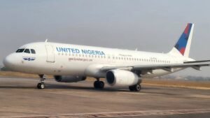 Lagos, Nigeria: Nigeria’s aviation sector is facing mounting operational and financial strain as soaring jet fuel prices and worsening supply shortages trigger widespread flight disruptions, route cuts and growing safety concerns across the country’s domestic airline industry. Industry officials and airline operators say the crisis has intensified in recent weeks despite government intervention efforts and increased local refining capacity from the Dangote Refinery, which began full-scale operations earlier this year. Airlines argue that while domestic production has improved supply volumes, the price of Jet A1 aviation fuel remains prohibitively high under Nigeria’s deregulated fuel market. According to the National Association of Aircraft Pilots and Engineers (NAAPE), persistent fuel scarcity has caused repeated flight delays, last-minute schedule changes and route cancellations as carriers struggle to secure sufficient supplies for daily operations. The association warned that prolonged disruptions are also forcing extended crew duty periods, raising concerns over fatigue and operational safety in an industry governed by strict rest regulations. NAAPE President Captain Bunmi Gindeh said the shortages were stretching operational planning and placing additional pressure on pilots, engineers and airline personnel. Domestic carriers have reported that jet fuel prices have risen dramatically since February, with some operators stating costs have more than quadrupled in recent months. Airlines say fuel expenses now account for between 30% and 40% of operating costs in Nigeria, significantly above the global average, making several domestic routes commercially unviable. Local airline Rano Air stated that the sustained increase in fuel prices had forced operational adjustments and schedule revisions. Other carriers have reportedly begun cutting unprofitable routes and rescheduling flights to reduce exposure to escalating fuel costs. The Airline Operators of Nigeria (AON), representing the country’s domestic airlines, had earlier threatened to suspend nationwide flight operations after accusing fuel marketers of imposing “astronomical and artificial” increases in Jet A1 prices. The group warned that the crisis was pushing airlines toward unsustainable losses and could have broader economic implications affecting employment, banking operations and national connectivity. The dispute prompted emergency talks with the Nigerian government in April, leading airlines to temporarily suspend their planned shutdown following appeals from Aviation Minister Festus Keyamo. As part of emergency relief measures, Nigerian authorities introduced temporary price caps on aviation fuel and allowed airlines to purchase fuel on credit for a limited period. Regulators also proposed direct fuel supply arrangements between marketers and airlines, debt relief measures for operators and discussions with Dangote Refinery over pricing mechanisms. Under the temporary framework, the Nigerian Midstream and Downstream Petroleum Regulatory Authority (NMDPRA) capped jet fuel prices between 1,760 and 1,988 naira per litre in Lagos and between 1,809 and 2,037 naira per litre in Abuja based on April benchmark pricing. Despite those measures, airlines say market conditions remain volatile. Nigeria’s aviation industry continues to face broader structural challenges including foreign exchange shortages, high aircraft maintenance costs, limited access to spare parts and inadequate airport infrastructure. The crisis has unfolded alongside wider global disruptions in the aviation fuel market linked to escalating tensions in the Middle East and instability surrounding shipping routes through the Strait of Hormuz. Airlines worldwide have reported major increases in fuel-related costs.