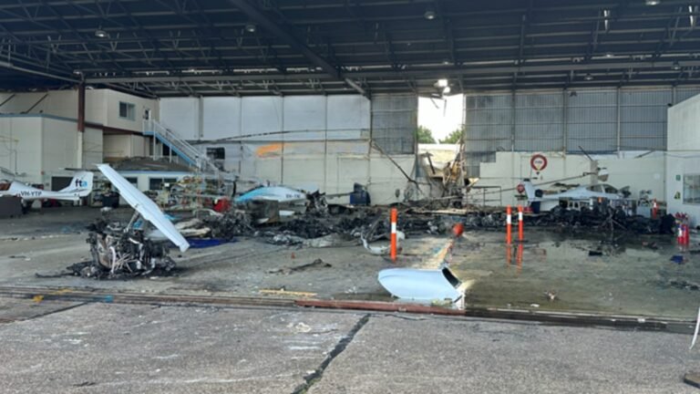 Adelaide, Australia: A fractured nose landing gear actuator has emerged as a significant focus of the Australian Transport Safety Bureau's (ATSB) investigation into the fatal Diamond DA42 training aircraft crash at Parafield Airport, South Australia, which killed two pilots and injured nine people on the ground. The findings were released on June 23, 2026, in a preliminary report into the April 29 accident involving Diamond DA42 Twin Star aircraft VH-YQP, operated by Flight Training Adelaide (FTA). The ATSB emphasized that the report is preliminary and does not determine the final cause of the accident. The aircraft departed Runway 03 Left at Parafield Airport at approximately 2:08 p.m. local time while conducting a training flight involving simulated engine-failure exercises. On board were a 24-year-old pilot under instruction and 29-year-old flight instructor Robert Hoyle. According to investigators, the aircraft initially climbed normally before CCTV footage showed it deviating left of the runway centerline. The aircraft was briefly realigned before veering left again. During the climb, the main landing gear retracted, but the nose landing gear remained extended. Approximately 27 seconds after takeoff, at about 115 feet above ground level, the instructor transmitted an "engine failure" radio call. No further transmissions were received. The aircraft continued climbing and reached a maximum recorded altitude of approximately 161 feet above ground level before entering a loss-of-control sequence. Investigators said the aircraft subsequently pitched up, rolled left, and descended steeply before colliding with a Flight Training Adelaide classroom and hangar complex. The impact triggered a major fire that destroyed the aircraft and damaged several others on the ground. Both occupants were fatally injured. Nine people on the ground sustained injuries, including several who required hospitalization. A key discovery during the wreckage examination was a fractured nose landing gear actuator rod end. ATSB investigators determined that the component had separated from the landing gear assembly. Preliminary examination found evidence of progressive fatigue cracking before the final fracture occurred. "The circumstances of the accident were consistent with pre-accident fracture of the rod end, resulting in the nose landing gear being observed down while the main gear was retracted," the ATSB stated. Investigators are examining whether the detached actuator may have interfered with the aircraft's steering and rudder control systems. The ATSB noted that Diamond Aircraft Industries had previously identified similar failures and issued mandatory service bulletins in 2013 and 2019 following other nose landing gear actuator fractures in DA42 aircraft. One previously documented occurrence described by the manufacturer involved a fractured actuator moving out of position and interacting with rudder controls, causing an uncommanded left rudder deflection. In that case, the pilot regained control after extending the landing gear. ATSB Chief Commissioner Angus Mitchell highlighted the significance of that earlier event. "In the DA42, re-extending the landing gear after take-off may not be a usual action considered by pilots, but as noted in the manufacturer's service bulletin explanation of a previous incident, this action allowed the pilot to regain aircraft control," Mitchell said. As a result of the findings, the ATSB has issued Safety Advisory Notice AO-2026-074-SAN-001 to alert DA42 operators to the increased risk of uncommanded left rudder deflection following a nose landing gear actuator fracture. The investigation is also focusing on the aircraft's engines. Examination of the wreckage found that the left engine showed no indications of producing power at impact, while the left propeller was found in the feathered position. Investigators have not yet determined whether the engine issue was genuine, simulated as part of the training exercise, or developed during the flight. The ATSB stated that multiple scenarios remain under consideration. The preliminary report also highlighted that Flight Training Adelaide's procedures required simulated engine-failure exercises after takeoff to be conducted no lower than 400 feet above ground level. The accident aircraft never exceeded 161 feet. To date, investigators have examined the wreckage, reviewed maintenance and operational records, obtained air traffic control data, analyzed ADS-B flight tracking information, collected CCTV footage, and interviewed witnesses. Further work will include detailed metallurgical examination of the fractured actuator component, engine analysis, review of recorded data, maintenance documentation, operational procedures, survivability considerations, and comparisons with related occurrences. The ATSB stressed that its role is to improve transport safety rather than assign blame. "The ATSB is also considering other scenarios to explain the accident sequence," the bureau said. The investigation remains active, and a final report is expected following completion of the technical analysis. The ATSB said any critical safety issues identified before then will be communicated immediately to relevant parties so corrective action can be taken.