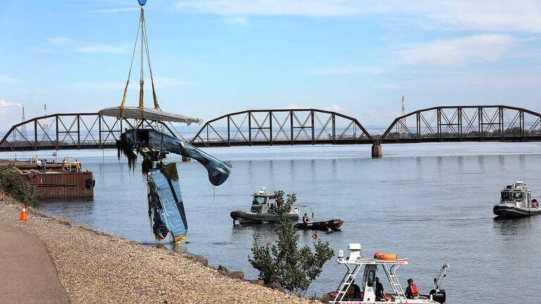 Washington, United States: Two California men were killed after their float-equipped aircraft struck a high-voltage transmission line and crashed into the Columbia River near the Tri-Cities area of southeastern Washington on Wednesday afternoon, triggering widespread power outages, a brush fire, and a large-scale emergency response. The accident occurred at approximately 2:29 p.m. PDT on June 24 near the Cable Bridge and Clover Island, between Pasco and Kennewick. According to emergency officials, the aircraft collided with a transmission line spanning the Columbia River before overturning and crashing into the water. Authorities later identified the victims as Randy J. Peterson, 64, of Sonoma, California, who was piloting the aircraft, and Eric Wayne Houston, 50, also of Sonoma, who was traveling as a passenger. The Franklin County Coroner confirmed both men died at the scene. Officials said the pair had departed California earlier that day and were en route to Priest Lake, Idaho, where they planned to attend a gathering of seaplane enthusiasts. Witnesses reported seeing the aircraft flying unusually low over the Columbia River moments before the crash. According to accounts provided to local media, the pilot appeared to be attempting to fly beneath the transmission lines crossing the river when the aircraft struck one of the lower power cables. The impact severed the transmission line, causing extensive power outages across the Tri-Cities region. Benton Public Utility District reported that more than 11,000 customers lost electricity. The power outage extended south of the Columbia River from Highway 395 west toward Leslie Road and affected almost 20% of the public utility district’s customers. Franklin PUD also reported a power outage to about 1,800 customers in Pasco north of the Columbia River to Interstate 182. The downed power line also ignited a brush fire near Riverview Park and the Pasco Youth Baseball Complex. Firefighters quickly contained the blaze before it could spread further. Multiple emergency agencies responded immediately to the crash, including the Pasco Fire Department, Pasco Police Department, Franklin County Sheriff's Office, Benton County Sheriff's Office, Columbia Basin Dive Rescue, the U.S. Coast Guard, Washington State Patrol, and utility crews from Benton PUD and Franklin PUD. Several witnesses reportedly entered the river in an attempt to rescue the occupants before emergency crews arrived. However, the aircraft had overturned and both occupants were trapped inside. Rescue personnel later recovered the victims from the submerged aircraft. The floatplane remained partially afloat before drifting downstream, where responders secured it using rescue boats. A crane was later used to lift the wreckage from the Columbia River for investigators. The Washington Department of Ecology also responded to monitor the river for any fuel spill. Officials later determined there was no significant environmental impact, stating that only a small amount of fuel had escaped and quickly dissipated. The National Transportation Safety Board (NTSB) has launched an investigation into the accident, with assistance from the Federal Aviation Administration (FAA) and local law enforcement. Investigators are expected to examine the aircraft's maintenance history, pilot qualifications, weather conditions, flight path, and the circumstances that led to the collision with the transmission line. The Franklin County Sheriff's Office is coordinating the local investigation while federal authorities determine the probable cause of the crash. Publicly available Federal Aviation Administration registration records indicate the float-equipped aircraft was registered in Sonoma, California. However, authorities have not officially identified the registered owner, and investigators have not released additional ownership details. Emergency responders stated that numerous agencies worked together to secure the crash site, recover the victims, restore power, extinguish the brush fire, and ensure public safety throughout the incident. The NTSB said it is investigating the circumstances surrounding the crash and will release additional information as the investigation progresses. A preliminary report is expected in the coming weeks, while the final report may take several months. The cause of the accident remains under investigation.
