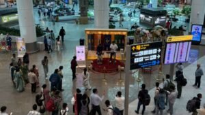 New Delhi, India: The Directorate General of Civil Aviation (DGCA) has intensified its warning against unauthorized photography and videography inside sensitive areas of airports across India, cautioning passengers that creating reels, vlogs, livestreams, or other social media content in restricted zones could attract serious penalties, including denial of boarding, confiscation of recording devices, and potential inclusion on a no-fly list in severe cases. The regulator's move comes amid a sharp rise in passengers documenting their travel experiences on social media platforms. According to reports, authorities have become increasingly concerned that seemingly harmless travel content may unintentionally capture sensitive security-related information, airport infrastructure, surveillance systems, operational procedures, or restricted facilities that are not meant for public dissemination. Under the restrictions, passengers are prohibited from conducting unauthorized photography or videography in security-sensitive areas of airports. These include security checkpoints, boarding areas, Security Hold Areas (SHA), runway buses, aircraft handling zones, airside operational areas, taxiways, and other restricted sections of airport infrastructure. Authorities say recording activities in such locations could compromise aviation security and operational safety. The DGCA's warning highlights that violations may result in a range of enforcement measures depending on the seriousness of the incident. Security personnel may direct passengers to stop filming, delete recorded material, or surrender devices for inspection. More serious violations could lead to fines, denial of boarding, security investigations, and recommendations for travel restrictions. Media reports indicate that repeat or severe offenders could face action under India's no-fly framework, although authorities have not yet released detailed criteria regarding how such cases would be evaluated. Officials have emphasized that the objective is not to prohibit all photography at airports but to prevent the disclosure of information that could pose security risks. The growing popularity of social media content creation has resulted in an increasing number of videos showing airport operations, security arrangements, access points, screening procedures, and other sensitive infrastructure. Aviation and security authorities believe such material could be exploited if widely circulated online. Airport authorities continue to permit photography in designated public areas where such activities are allowed. Passengers taking selfies or personal photographs in non-restricted terminal spaces are generally not the focus of the restrictions. However, travelers are being advised to carefully follow airport signage and instructions issued by security agencies, airline personnel, and airport operators before recording any content. The DGCA has also reiterated that commercial filming projects, promotional shoots, media productions, and influencer collaborations remain permissible only after obtaining the necessary approvals through authorized channels. Individuals and organizations seeking to conduct professional filming activities at airports must secure prior permissions in accordance with existing aviation and security regulations. The latest warning reflects a broader push by aviation authorities to strengthen security oversight across India's airport network as passenger traffic continues to grow. Regulators are urging travelers to exercise caution when creating content at airports and to avoid filming any area designated as restricted or security-sensitive.