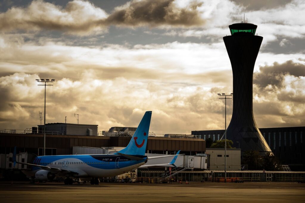 Edinburgh, Scotland: Edinburgh Airport resumed operations on Saturday after a major security incident forced the evacuation of the terminal, the closure of surrounding roads, and widespread disruption to flights and ground transport services. The incident began at approximately 6:50 p.m. local time on Friday, June 19, when authorities received reports of a potentially suspicious package at the airport. Police Scotland immediately launched a security response, ordering the evacuation of the terminal building while specialist Explosive Ordnance Disposal (EOD) teams were deployed to assess the item. A security cordon was established around the airport, and several access roads were closed as bomb disposal experts conducted their investigation. Hundreds of passengers were evacuated from the terminal and directed away from the airport while emergency personnel secured the area. According to Police Scotland, the evacuation was implemented as a precautionary measure following the report of the suspicious package. Officers urged travelers to contact their airlines for updates and warned of significant disruption while enquiries were ongoing. Airport operator Edinburgh Airport confirmed that specialist teams were investigating the item and advised passengers to check directly with their airlines before travelling to the airport. Flight operations were significantly affected throughout the evening. Multiple arriving aircraft were diverted to alternative airports, including Glasgow Airport, while numerous departures were delayed or suspended. Several flights reportedly entered holding patterns or altered their routes as the security operation unfolded. Ground transportation services were also disrupted. Coach operator Citylink announced that its airport services were unable to access the terminal because of the ongoing incident. Temporary pickup and drop-off arrangements were established at nearby locations, including the Moxy Hotel and Hilton Hotel bus stops. The airport remained largely shut down for several hours while EOD specialists examined the package. Operations began returning to normal during the early hours of Saturday after authorities completed their assessment and lifted restrictions. The prolonged closure created knock-on effects across airline schedules, with passengers warned to expect delays and operational disruptions as carriers worked to reposition aircraft and recover their networks. As of Saturday morning, airport operations had resumed, although airlines continued to advise travelers to verify the status of their flights before heading to the airport. Police Scotland has not announced any arrests in connection with the incident, and investigations into the circumstances surrounding the discovery remain ongoing.