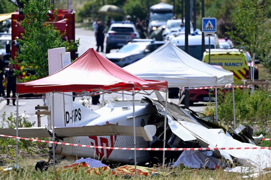 Tomblaine, France: Eleven people were killed after a skydiving aircraft crashed shortly after takeoff near Nancy in northeastern France on Sunday, June 28, in one of the country's deadliest civilian aviation accidents involving a parachuting flight in decades. The aircraft, identified by authorities as a German-registered Pilatus PC-6, departed from Nancy-Essey Airport at approximately 11:00 a.m. local time before suffering what officials described as a malfunction moments after becoming airborne. The aircraft crashed in the commune of Tomblaine, around 300 metres from the end of the runway, killing everyone on board. The victims included the pilot, five skydiving instructors and five trainee parachutists, according to regional authorities. No one survived the crash. According to Meurthe-et-Moselle Prefect Yves Séguy, the aircraft encountered a malfunction shortly after departure from Nancy-Essey Airport. Officials said the airplane lost altitude rapidly and plunged almost vertically before striking the ground near a bicycle path adjacent to a commercial area. Despite the severity of the accident, the aircraft narrowly missed nearby residential buildings, preventing what authorities said could have been an even greater tragedy. Investigators have not yet determined the precise cause of the accident. Witnesses reported hearing the aircraft's engine suddenly fall silent shortly after takeoff, followed almost immediately by the impact. Several residents told local media the aircraft appeared to descend without any obvious attempt to return to the airport. Authorities said there was no evidence of an in-flight explosion or significant post-impact fire, although the aircraft was completely destroyed upon impact. The aircraft was being used for a scheduled parachuting flight operated by a skydiving school. French authorities confirmed the aircraft was registered in Germany, although officials have not yet publicly identified the operator or ownership details. The Swiss-built Pilatus PC-6 Porter is widely used around the world for parachuting operations because of its excellent short takeoff and landing performance, high-wing configuration and ability to carry multiple skydivers. The flight was carrying 10 parachutists, comprising five instructors and five students, along with the pilot. Several reports indicated the students were preparing for tandem skydives. Some media outlets reported that the trainee participants included nursing professionals from the Nancy area taking part in a recreational skydiving experience. However, French authorities have not officially released the identities of any victims. Officials confirmed that some relatives and friends of those on board had gathered at the airport to watch the planned parachute jumps. Several family members reportedly witnessed the aircraft's fatal descent shortly after takeoff. Emergency psychological support teams were deployed to assist grieving relatives, witnesses and first responders. More than 50 firefighters, police officers, emergency medical teams and specialist aviation investigators responded to the scene. Authorities established a security perimeter around the crash site and urged members of the public to stay away while rescue and recovery operations continued. French Interior Minister Laurent Nuñez travelled to the scene, while Transport Minister Philippe Tabarot described the accident as a "terrible tragedy" and extended condolences to the victims' families. The wreckage remained under guard as investigators began documenting evidence and recovering aircraft components. France's aviation accident investigators have launched a formal investigation into the crash. Authorities have stressed that no cause has yet been established. Although northeastern France experienced exceptionally high temperatures the day before the accident, investigators have not linked the weather to the crash. Witness reports that the engine appeared to stop shortly after takeoff will form part of the investigation, but officials cautioned that eyewitness accounts alone cannot determine the cause. Unlike many larger commercial aircraft, the Pilatus PC-6 is generally not equipped with a cockpit voice recorder or flight data recorder, meaning investigators will rely heavily on physical evidence, maintenance documentation, operational records and witness testimony. As investigators continue examining the wreckage, authorities have urged the public to avoid speculation until the official investigation determines what caused the aircraft to crash so soon after takeoff.