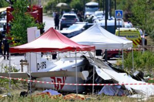Tomblaine, France: Eleven people were killed after a skydiving aircraft crashed shortly after takeoff near Nancy in northeastern France on Sunday, June 28, in one of the country's deadliest civilian aviation accidents involving a parachuting flight in decades. The aircraft, identified by authorities as a German-registered Pilatus PC-6, departed from Nancy-Essey Airport at approximately 11:00 a.m. local time before suffering what officials described as a malfunction moments after becoming airborne. The aircraft crashed in the commune of Tomblaine, around 300 metres from the end of the runway, killing everyone on board. The victims included the pilot, five skydiving instructors and five trainee parachutists, according to regional authorities. No one survived the crash. According to Meurthe-et-Moselle Prefect Yves Séguy, the aircraft encountered a malfunction shortly after departure from Nancy-Essey Airport. Officials said the airplane lost altitude rapidly and plunged almost vertically before striking the ground near a bicycle path adjacent to a commercial area. Despite the severity of the accident, the aircraft narrowly missed nearby residential buildings, preventing what authorities said could have been an even greater tragedy. Investigators have not yet determined the precise cause of the accident. Witnesses reported hearing the aircraft's engine suddenly fall silent shortly after takeoff, followed almost immediately by the impact. Several residents told local media the aircraft appeared to descend without any obvious attempt to return to the airport. Authorities said there was no evidence of an in-flight explosion or significant post-impact fire, although the aircraft was completely destroyed upon impact. The aircraft was being used for a scheduled parachuting flight operated by a skydiving school. French authorities confirmed the aircraft was registered in Germany, although officials have not yet publicly identified the operator or ownership details. The Swiss-built Pilatus PC-6 Porter is widely used around the world for parachuting operations because of its excellent short takeoff and landing performance, high-wing configuration and ability to carry multiple skydivers. The flight was carrying 10 parachutists, comprising five instructors and five students, along with the pilot. Several reports indicated the students were preparing for tandem skydives. Some media outlets reported that the trainee participants included nursing professionals from the Nancy area taking part in a recreational skydiving experience. However, French authorities have not officially released the identities of any victims. Officials confirmed that some relatives and friends of those on board had gathered at the airport to watch the planned parachute jumps. Several family members reportedly witnessed the aircraft's fatal descent shortly after takeoff. Emergency psychological support teams were deployed to assist grieving relatives, witnesses and first responders. More than 50 firefighters, police officers, emergency medical teams and specialist aviation investigators responded to the scene. Authorities established a security perimeter around the crash site and urged members of the public to stay away while rescue and recovery operations continued. French Interior Minister Laurent Nuñez travelled to the scene, while Transport Minister Philippe Tabarot described the accident as a "terrible tragedy" and extended condolences to the victims' families. The wreckage remained under guard as investigators began documenting evidence and recovering aircraft components. France's aviation accident investigators have launched a formal investigation into the crash. Authorities have stressed that no cause has yet been established. Although northeastern France experienced exceptionally high temperatures the day before the accident, investigators have not linked the weather to the crash. Witness reports that the engine appeared to stop shortly after takeoff will form part of the investigation, but officials cautioned that eyewitness accounts alone cannot determine the cause. Unlike many larger commercial aircraft, the Pilatus PC-6 is generally not equipped with a cockpit voice recorder or flight data recorder, meaning investigators will rely heavily on physical evidence, maintenance documentation, operational records and witness testimony. As investigators continue examining the wreckage, authorities have urged the public to avoid speculation until the official investigation determines what caused the aircraft to crash so soon after takeoff.