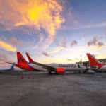 New Delhi, India: The Government of India has approved a ₹10,000 crore (approximately US$1.05 billion) Aviation Turbine Fuel (ATF) Price Stabilisation Fund aimed at shielding domestic airlines from an unprecedented surge in jet fuel prices triggered by the ongoing Iran conflict and disruptions to global energy supplies. The decision, approved by the Union Cabinet on June 3, comes as Indian carriers face mounting operational and financial pressure from rapidly escalating fuel costs, which have more than doubled in recent months and threaten to push airfares higher, reduce capacity and impact aviation-led economic growth. The relief package follows a sharp increase in ATF prices caused by geopolitical tensions in the Middle East, particularly the conflict involving Iran, which has disrupted oil markets and raised concerns over supplies moving through the Strait of Hormuz. The strategic waterway handles roughly one-fifth of the world's oil shipments, making any disruption a major concern for global energy markets. As crude oil prices climbed, ATF costs in India surged from around ₹60.50 per litre in March to nearly ₹142 per litre in May, according to government figures. Fuel is the single largest expense for most Indian airlines and typically accounts for approximately 35-40 percent of total operating costs. The sudden rise in prices has significantly increased cost pressures across the sector. Rather than directly subsidising airlines, the government will provide interest-free advances to state-run oil marketing companies. These funds will enable oil suppliers to moderate ATF price increases and reduce the immediate financial burden on airlines purchasing fuel. Officials said the measure is intended to cushion airlines from extreme fuel-price volatility while maintaining stability across the broader aviation ecosystem. The government believes the intervention will help: Prevent sharp airfare increases for passengers. Protect airline profitability and financial stability. Maintain domestic and international air connectivity. Support employment linked to the aviation sector. Sustain growth in one of the world's fastest-growing aviation markets. According to Petroleum and Natural Gas Minister Hardeep Singh Puri, the measure aims to safeguard approximately 7.7 million jobs associated with India's aviation industry. The government's move comes after several signs of stress emerged across the airline sector. Recent reports indicated that major carriers, including IndiGo and Air India, had already reduced domestic capacity during the June-July travel period in response to soaring fuel costs and operational challenges. Globally, airline executives have also identified fuel costs arising from the Iran conflict as one of the industry's most significant challenges since the COVID-19 pandemic. India's largest airline, IndiGo, welcomed the announcement and described it as a significant step for the aviation sector. An IndiGo spokesperson said, "We are grateful to the Government of India, the Ministry of Civil Aviation, the Ministry of Petroleum and Natural Gas, and all concerned authorities for introducing ATF price stabilisation support for Indian airlines. This timely measure recognizes aviation's vital role in connectivity and economic growth, while helping airlines serve passengers better and supporting India's ambition to become a global aviation hub." The airline indicated that the measure would help carriers continue investing in network expansion and operational reliability while maintaining affordable air travel for passengers. While the government has not specified the exact reduction in ATF prices that airlines may receive, the stabilisation mechanism is expected to ease immediate cost pressures and prevent further steep increases. The support may also help carriers avoid passing the full burden of fuel inflation to passengers during the peak travel season.