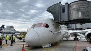 Frankfurt, Germany: A Lufthansa Boeing 787-9 Dreamliner suffered a nose landing gear collapse while parked at a gate at Frankfurt Airport on June 4, 2026, injuring several crew members and ground staff and forcing the cancellation of a scheduled flight to Los Angeles. The aircraft involved was Lufthansa flight LH450 from Frankfurt to Los Angeles, operated by Boeing 787-9 Dreamliner D-ABPQ, named "Herne." The incident occurred at approximately 12:45 p.m. local time while the aircraft was being prepared for departure and was still connected to the passenger boarding bridge. According to Lufthansa, passengers had not yet boarded the aircraft when the collapse occurred. However, crew members and ground personnel were onboard carrying out pre-departure preparations. Several employees sustained injuries and received medical treatment. The airline has not disclosed the exact number of injured personnel or the severity of their injuries. Video footage captured by airport cameras and widely circulated on social media shows the aircraft's nose suddenly dropping to the ground as the forward landing gear unexpectedly folded. Emergency vehicles responded quickly and surrounded the aircraft shortly after the incident. Images from the scene indicate substantial damage to the nose section of the Dreamliner. The aircraft came to rest with its forward fuselage on the apron after the nose landing gear collapsed. The impact reportedly damaged the nose gear bay doors and surrounding structural components. Some reports also suggested that parts of the aircraft's lower fuselage and associated structures may have contacted the ground during the collapse. The Boeing 787-9 involved is one of Lufthansa's newest long-haul aircraft. Flight-tracking data shows the aircraft was delivered to Lufthansa in January 2025 and entered commercial service in February 2025. Since entering service, it had completed approximately 137 flights before the incident. Lufthansa confirmed that an investigation has been launched in coordination with the relevant authorities. Boeing stated that it is aware of the event and is supporting the airline during the investigation. At present, investigators have not determined the cause of the collapse. Aviation experts note that a nose landing gear failure while an aircraft is stationary at a gate is extremely uncommon. The investigation is expected to focus on maintenance records, landing gear system components, hydraulic systems, and any maintenance procedures that may have been conducted before departure. Lufthansa aircraft appear to show the nose gear folding forward rather than collapsing under landing loads, leading to a possibility that an unintended gear retraction event could have occurred. Nevertheless, investigators have not confirmed any such scenario, and the exact sequence of events remains under examination. The scheduled Los Angeles service was cancelled as investigators began examining the aircraft and gathering evidence to determine what caused the unexpected failure. Lufthansa said it is continuing to work with authorities to establish the exact circumstances surrounding the incident.