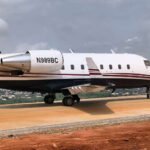 Lagos, Nigeria: The Nigeria Civil Aviation Authority (NCAA) has grounded a privately operated aircraft and suspended the operator's Permit for Non-Commercial Flight (PNCF) after the aircraft conducted an unauthorized flight to Lagos following an emergency landing near Asaba in Delta State. The aircraft involved was a Canadair CL-600-2B16 Challenger 601-3A, registration N989BC, owned and operated by Best Aircraft Deals LLC. The regulator announced the enforcement action in a statement issued on Wednesday by Director of Public Affairs and Consumer Protection Michael Achimugu, who confirmed that a full investigation has been launched into the occurrence. According to preliminary information released by the NCAA, the aircraft was attempting to land at Asaba Airport when the crew executed a missed approach at approximately 7:43 a.m. local time. The aircraft subsequently carried out an emergency landing on a roadway in the Ogwashi-Uku area, outside the airport environment. Authorities reported that all four crew members on board safely evacuated the aircraft after landing. No injuries were recorded, and the occupants were later transported to Asaba by road. While the emergency landing itself ended without casualties, the NCAA's concerns intensified after learning that the aircraft later departed the scene and flew to Lagos without obtaining the required regulatory authorization. According to the regulator, preliminary findings indicate that the aircraft took off from the location at approximately 11:02 GMT and returned to Lagos without prior approval from the authority. The NCAA further stated that Air Traffic Control was reportedly notified only after the aircraft had already become airborne. The authority described the action as a potential violation of the Nigerian Civil Aviation Regulations and immediately grounded the aircraft upon its arrival in Lagos pending the outcome of ongoing investigations. In addition, the flight crew has been placed under regulatory review while investigators examine the circumstances surrounding both the emergency landing and the subsequent unauthorized flight. As part of the enforcement measures, the NCAA suspended the operator's Permit for Non-Commercial Flight and ordered a comprehensive review of all operational, maintenance, airworthiness and flight-related records associated with the aircraft and operator. The authority has also notified the Nigerian Safety Investigation Bureau (NSIB) and is coordinating with the Nigerian Airspace Management Agency (NAMA) and other aviation stakeholders to establish the full sequence of events. The regulator stated that the actions were necessary to preserve aviation safety and ensure compliance with established operational procedures while the investigation remains underway.