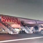 New Delhi, India: India's Aircraft Accident Investigation Bureau (AAIB) has released its preliminary findings into the serious incident involving a Swiss International Air Lines Airbus A330-343 that suffered a left-engine failure during takeoff at Delhi's Indira Gandhi International Airport, forcing the crew to reject takeoff and conduct an emergency evacuation. The incident occurred shortly after 1:27 a.m. local time on April 26, 2026, when Swiss flight LX147 was preparing to depart Delhi for Zurich with 245 people onboard, including 232 passengers and 13 crew members. According to the AAIB report, the aircraft involved was a 2012-built Airbus A330-343, registered HB-JHK, powered by Rolls-Royce Trent 772B-60 engines. The aircraft had arrived in Delhi earlier that day, operating flight LX146 from Zurich. Investigators noted that the inbound Zurich–Delhi flight was uneventful. While seven maintenance complaints were logged after arrival, all were described as routine and unrelated to the aircraft's engines, flight controls, serviceability, or controllability. The reported issues were addressed before the aircraft was cleared for the return flight to Switzerland. No abnormalities were detected during pre-flight inspections before LX147's departure from Delhi. The aircraft, parked at Stand A14, received pushback and startup clearance before taxiing to Runway 28 via taxiway J6. At 01:25:56 IST, air traffic control cleared the flight for takeoff with light winds reported from 210 degrees at one knot. Moments later, during the takeoff roll, the aircraft accelerated to approximately 106 knots. According to cockpit reports cited by investigators, the crew heard a loud bang as the No. 1 engine experienced a failure. Pilots reported seeing a large flame projecting forward from the left engine and observed the aircraft veering left. The crew immediately rejected the takeoff and brought the aircraft to a stop on Runway 28 between taxiways G1 and G2. After stopping, the flight crew informed air traffic controllers of the engine failure and requested emergency services. Communications recorded by investigators show that airport vehicles and crash fire tenders responded rapidly. Initially, responders observed smoke around the aircraft. As emergency personnel continued assessing the situation, reports indicated smoke near the left landing gear and subsequently fire near the right landing gear area. Fire crews began firefighting operations while coordinating with air traffic controllers and the flight crew. At approximately 01:35 IST, a full airport emergency was declared. Following confirmation of smoke and fire indications, both engines were shut down. Emergency evacuation procedures were initiated directly on the runway. Seven of the aircraft's eight evacuation slides were deployed and used to evacuate passengers and crew. All occupants successfully exited the aircraft. Four passengers sustained injuries during the evacuation and were transported for medical treatment. Airport responders reported that the fire had been completely extinguished by approximately 01:50 IST. The aircraft was later towed from the runway and parked at a remote stand. The airport terminated the full emergency status at 04:50 IST. Data obtained from the aircraft's post-flight report showed the first recorded warning was an "ENG 1 Stall" message at 01:27 IST during the takeoff roll. This was followed by multiple system messages including "ENG 1 FAIL," "AIR PACK 1+2 FAULT," "F/CTL RUD TRIM 1 FAULT," and "ENG 1 REV UNLOCKED." An "ENG 1 SHUTDOWN" message was subsequently recorded after the aircraft came to a stop. Investigators conducted an external inspection of the aircraft and found metallic debris near the exhaust section of the left engine along with soot and burn marks on the engine pylon behind the exhaust area. Notably, no damage was observed on the engine fan blades, and investigators reported no significant structural damage to the aircraft apart from minor dents likely caused during emergency slide deployment. A borescope inspection of the failed engine revealed extensive internal damage. Investigators discovered broken bolts and spacers from the high-pressure/intermediate-pressure bearing support assembly within the thrust reverser ducts. High-pressure bleed valves were also partially blocked by debris. Further examination identified significant damage to components within the engine core, including the High Pressure Turbine, Intermediate Pressure Turbine, Low Pressure Turbine, and High Pressure Compressor sections. Both the high-pressure and intermediate-pressure shafts were seized, preventing complete inspection. The AAIB stated that although severe internal engine damage was identified, investigators were unable to determine the precise cause of the engine failure during the initial borescope examination because the engine's rotating assemblies could not be fully inspected. Importantly, investigators found no evidence of an uncontained engine failure. The failed Rolls-Royce Trent 772B-60 engine was manufactured in 2009 and had accumulated more than 75,500 operating hours and 11,369 flight cycles. Records show the engine's last overhaul occurred in May 2016. Since that overhaul, it had accumulated nearly 40,000 additional flight hours before the incident. Both cockpit crew members were appropriately licensed and qualified on the Airbus A330. The captain had more than 18,600 total flight hours, while the first officer had accumulated more than 2,170 hours. AAIB investigators have removed and downloaded data from both the cockpit voice recorder and flight data recorder. Analysis of the recorded information is ongoing. The bureau said the damaged engine will be removed from the aircraft for a detailed examination aimed at identifying the root cause of the failure. Investigators are also reviewing maintenance records, operational documentation, air traffic control recordings, and witness statements. The investigation includes participation from international authorities and technical experts. France's Bureau d'Enquêtes et d'Analyses (BEA), Airbus, the European Union Aviation Safety Agency (EASA), Germany's BFU, the United Kingdom's AAIB, and Rolls-Royce representatives are assisting the Indian investigation under the provisions of ICAO Annex 13. The AAIB emphasized that the findings released so far are preliminary and subject to change as the investigation progresses. No interim safety recommendations have been issued at this stage.