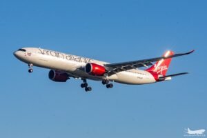 Shannon, Ireland: A Virgin Atlantic Airbus A330-900neo operating a scheduled service from London Heathrow to Montego Bay, Jamaica, made an emergency diversion to Shannon Airport in Ireland on May 30 after suffering an in-flight engine malfunction while crossing the North Atlantic. Flight VS165 departed London Heathrow at approximately 1604 UTC and was operating normally at cruising altitude when the crew encountered a problem involving the aircraft’s right-hand Rolls-Royce Trent 7000 engine nearly three hours into the transatlantic crossing. The aircraft, registered G-VTOM, was cruising at Flight Level 360 approximately 440 nautical miles west of Shannon when the right-hand engine experienced a stall. The flight crew subsequently reduced the engine to idle thrust and initiated diversion procedures. The aircraft then descended to Flight Level 200 and turned back toward Ireland. The Airbus A330-900 was carrying 246 passengers and 13 crew members at the time of the incident. With several hours of oceanic flight remaining to Montego Bay, the crew elected to continue on a single-engine profile and divert to the nearest suitable airport. Air traffic controllers coordinated the diversion to Shannon Airport, a major transatlantic emergency diversion facility frequently used by long-haul aircraft operating across the North Atlantic. Emergency response procedures were activated ahead of the aircraft’s arrival. The aircraft landed safely at Shannon at approximately 2124 local time after roughly five hours of flight. Emergency vehicles accompanied the aircraft during landing and rollout. Following a brief inspection by emergency personnel on the runway, no signs of fire or immediate hazards were detected, allowing the aircraft to taxi to a parking stand. All passengers and crew members disembarked safely. No injuries were reported. Passenger accounts provided additional insight into the event. Jamaican attorney Yushaine Morgan, who was travelling onboard the flight, told local media that passengers heard a loud bang approximately three hours after departure. He said a smell of smoke was detected in the cabin and that the captain subsequently informed passengers of an engine failure and the need to divert. Virgin Atlantic confirmed the diversion, describing it as a precautionary measure following a technical issue involving the aircraft. The airline did not officially disclose the exact nature of the malfunction. A spokesperson said the aircraft landed safely and apologised for the disruption caused to passengers. The airline arranged a replacement aircraft and provided accommodation, rebooking options, alternative travel arrangements, and refund options for affected customers. Following arrival in Shannon, passengers reportedly remained at the airport for several hours before being transported back to London Heathrow on a replacement aircraft. Some passengers were subsequently rebooked on later services to Jamaica, subject to seat availability. The incident is expected to be reviewed by Virgin Atlantic engineers and relevant aviation authorities. Investigators will examine flight data, engine performance information, maintenance records, and any onboard indications recorded during the event to determine the precise cause of the malfunction. The aircraft remained in Shannon following the diversion while technical inspections were carried out.