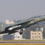 HAL Files Cheating & Forgery Case Over Fake Test Reports In Tejas Mk1A Supply Chain SEO DES: The case covers 2022–23 procurement of 172 parts across 35 categories; HAL found discrepancies in checks, and a lab denied issuing several certificates SOCIAL: HAL has filed a cheating and forgery case against a Hyderabad-based supplier over alleged 199 forged test reports linked to Tejas Mk1A aircraft components. The FIR names Tec Aero Devices and its CEO. The case covers 2022–23 procurement of 172 parts across 35 categories. HAL detected discrepancies during quality checks, and a lab reportedly denied issuing several certificates. HAL lodged a complaint in Bengaluru, debarred the supplier for three years, and confirmed no payments were made. The matter is under investigation. Image: Government of India (Wikimedia) Video: Bengaluru, India: Hindustan Aeronautics Limited (HAL) has filed a cheating and forgery case against a Hyderabad-based aerospace supplier over allegations that it submitted forged material test reports linked to components used in the Light Combat Aircraft (LCA) Tejas Mk1A programme. According to official complaints, HAL’s Aircraft Division has named Tec Aero Devices and its CEO M. Sivarama Prasad in the FIR, accusing them of cheating, criminal conspiracy, and forgery under relevant provisions of the Indian Penal Code. The case relates to procurement orders placed between March 2022 and September 2023 for 35 categories of components and 172 individual parts supplied for the indigenous fighter aircraft programme. HAL has alleged that the supplier submitted as many as 199 forged material test reports covering critical aerospace-grade components. These reports were reportedly linked to key testing parameters including tensile strength, hardness, shear load, corrosion resistance, and non-destructive testing. The discrepancies came to light during routine quality assurance checks conducted by HAL, which triggered a deeper internal review of the certification documents submitted by the vendor. As part of the investigation, HAL conducted verification with the laboratory mentioned in the test certificates. The lab reportedly denied issuing several of the documents attributed to it, stating that its name and credentials had been misused. This confirmation strengthened suspicions that the test reports were fabricated and not generated through authorised testing procedures. Following internal findings, HAL lodged a formal complaint with the HAL police station in Bengaluru, leading to the registration of an FIR. The case includes charges of cheating, forgery, forgery for the purpose of cheating, and criminal conspiracy. HAL has also initiated internal procurement action against the supplier, including issuing a show-cause notice and imposing a three-year debarment, barring the company from participating in future contracts until March 2027. Officials further confirmed that no payments were released for the disputed supplies, thereby limiting financial exposure. The incident has raised concerns over supply chain integrity within India’s defence manufacturing ecosystem, particularly in relation to the Tejas Mk1A programme, which is central to the Indian Air Force’s modernisation plans. The Light Combat Aircraft Mk1A is a key indigenous fighter platform under large-scale production, and stringent quality assurance is critical for ensuring airworthiness and operational safety. While HAL has not issued further comments beyond confirming the complaint and ongoing cooperation with authorities, the matter is now under police investigation. The case comes amid increased scrutiny of defence procurement processes and quality control mechanisms in high-value indigenous aerospace programmes. Investigators are expected to determine whether the alleged forgery was an isolated supplier-level issue or part of a broader malpractice within the supply chain.