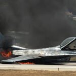 Greek Air Force F-16 Catches Fire After Emergency Belly Landing At Zakynthos Airport SEO DES: Pilot received an onboard fire warning before the F-16 belly-landed without landing gear, sliding along the runway before catching fire; pilot escaped safely. SOCIAL: A Hellenic Air Force F-16 fighter jet made an emergency belly landing at Zakynthos International Airport after a technical malfunction during a training flight. The pilot, who reportedly received an onboard fire warning before landing, escaped safely as the aircraft caught fire after sliding along the runway without its landing gear. The incident closed the airport's only runway, causing significant flight delays during Greece's peak summer travel season. Authorities have launched an investigation into the cause of the malfunction while recovery teams worked to clear the runway and restore airport operations. Zakynthos, Greece: A Hellenic Air Force F-16 fighter jet made an emergency belly landing at Zakynthos International Airport on Thursday after suffering a technical malfunction during a routine training mission, forcing the temporary closure of the airport's only runway and disrupting flights at the height of Greece's summer travel season. The pilot escaped without injury, while the aircraft caught fire after touching down, prompting an immediate response from airport firefighters and emergency personnel. According to the Hellenic Air Force, the incident occurred at approximately 13:45 local time (10:45 GMT) when the F-16, assigned to 335 Squadron of the 116th Combat Wing based at Araxos Air Base in western Greece, experienced an unspecified technical fault while conducting a training flight over the Ionian region. The aircraft diverted to Zakynthos Airport and executed an emergency landing. Military officials confirmed that the pilot was "in good health" and that an investigation has been launched to determine the cause of the malfunction. Greek media reported that the pilot received a cockpit indication of an onboard fire before landing. The fighter reportedly landed without deploying its landing gear, forcing it to perform a belly landing and slide for dozens of metres along the runway before coming to a stop. Shortly after the aircraft stopped, flames engulfed portions of the jet, leading airport fire crews to rapidly blanket the aircraft with foam and water to extinguish the blaze. Videos circulating widely on social media showed the F-16 engulfed in flames as firefighters worked to contain the fire. The pilot was seen exiting the aircraft safely before emergency responders intensified firefighting operations around the stricken jet. The incident forced the closure of Zakynthos Airport's single runway, bringing operations at one of Greece's busiest seasonal tourist gateways to a standstill. Flight information displays showed numerous arrivals and departures delayed until at least 21:00 local time, including several services that had originally been scheduled to depart hours earlier. Airport authorities awaited the arrival of a specialist Hellenic Air Force recovery team to remove the damaged fighter from the runway before normal operations could resume. The disruption came at the start of the peak summer holiday period, when Zakynthos popularly known as Zante welcomes thousands of international visitors every week, particularly from the United Kingdom and other European countries. With only one operational runway, even a single aircraft incident can significantly affect airport capacity and flight schedules. The Hellenic Air Force has not released additional technical details regarding the aircraft or the nature of the malfunction. Investigators are expected to examine the aircraft, maintenance records and flight data as part of the official inquiry into the emergency landing.