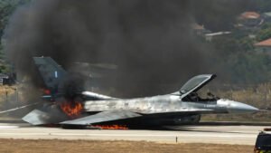 Greek Air Force F-16 Catches Fire After Emergency Belly Landing At Zakynthos Airport SEO DES: Pilot received an onboard fire warning before the F-16 belly-landed without landing gear, sliding along the runway before catching fire; pilot escaped safely. SOCIAL: A Hellenic Air Force F-16 fighter jet made an emergency belly landing at Zakynthos International Airport after a technical malfunction during a training flight. The pilot, who reportedly received an onboard fire warning before landing, escaped safely as the aircraft caught fire after sliding along the runway without its landing gear. The incident closed the airport's only runway, causing significant flight delays during Greece's peak summer travel season. Authorities have launched an investigation into the cause of the malfunction while recovery teams worked to clear the runway and restore airport operations. Zakynthos, Greece: A Hellenic Air Force F-16 fighter jet made an emergency belly landing at Zakynthos International Airport on Thursday after suffering a technical malfunction during a routine training mission, forcing the temporary closure of the airport's only runway and disrupting flights at the height of Greece's summer travel season. The pilot escaped without injury, while the aircraft caught fire after touching down, prompting an immediate response from airport firefighters and emergency personnel. According to the Hellenic Air Force, the incident occurred at approximately 13:45 local time (10:45 GMT) when the F-16, assigned to 335 Squadron of the 116th Combat Wing based at Araxos Air Base in western Greece, experienced an unspecified technical fault while conducting a training flight over the Ionian region. The aircraft diverted to Zakynthos Airport and executed an emergency landing. Military officials confirmed that the pilot was "in good health" and that an investigation has been launched to determine the cause of the malfunction. Greek media reported that the pilot received a cockpit indication of an onboard fire before landing. The fighter reportedly landed without deploying its landing gear, forcing it to perform a belly landing and slide for dozens of metres along the runway before coming to a stop. Shortly after the aircraft stopped, flames engulfed portions of the jet, leading airport fire crews to rapidly blanket the aircraft with foam and water to extinguish the blaze. Videos circulating widely on social media showed the F-16 engulfed in flames as firefighters worked to contain the fire. The pilot was seen exiting the aircraft safely before emergency responders intensified firefighting operations around the stricken jet. The incident forced the closure of Zakynthos Airport's single runway, bringing operations at one of Greece's busiest seasonal tourist gateways to a standstill. Flight information displays showed numerous arrivals and departures delayed until at least 21:00 local time, including several services that had originally been scheduled to depart hours earlier. Airport authorities awaited the arrival of a specialist Hellenic Air Force recovery team to remove the damaged fighter from the runway before normal operations could resume. The disruption came at the start of the peak summer holiday period, when Zakynthos popularly known as Zante welcomes thousands of international visitors every week, particularly from the United Kingdom and other European countries. With only one operational runway, even a single aircraft incident can significantly affect airport capacity and flight schedules. The Hellenic Air Force has not released additional technical details regarding the aircraft or the nature of the malfunction. Investigators are expected to examine the aircraft, maintenance records and flight data as part of the official inquiry into the emergency landing.