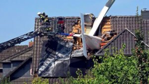 Ganderkesee, Germany: Two men were killed after a small private aircraft crashed into the roof of a residential house in Ganderkesee, in Germany’s Lower Saxony state, on Saturday, July 25, 2026, police said. The aircraft crashed at around 11 a.m. local time in a residential area near Oldenburg after apparently losing altitude for reasons that remain unknown. It struck the pitched roof of a single-family home head-on, becoming embedded in the structure. The aircraft was reportedly a single-engine, four-seat light aircraft manufactured by Italian company Tecnam and had taken off from Bremen shortly before the accident. The two people aboard the aircraft were men aged 65 and 77, both from Bremen, according to police. Initially, authorities confirmed that one occupant had died and said a second person was missing following the crash. Emergency crews spent several hours searching for the missing occupant, with the recovery operation complicated by the aircraft being lodged in the roof and concerns that the damaged house could be structurally unstable. The second occupant was eventually found dead, bringing the confirmed death toll to two. According to the Delmenhorst police department, the deaths of both occupants were established following lengthy and complex recovery operations involving the aircraft wreckage. The initial response was complicated by the position of the aircraft and the condition of the building. Emergency personnel could not safely enter the house from below because of the potential risk of collapse. Firefighters used a ladder platform to inspect the structure, but the second occupant could not initially be located. The aircraft wreckage was subsequently removed from the roof as part of the recovery operation. The residents of the house were not at home when the aircraft crashed, and no other injuries were reported. Authorities nevertheless evacuated residents living within approximately 100 metres of the crash site as a precaution. Electricity along the affected road was also temporarily switched off for safety reasons, while the area was cordoned off and emergency services carried out recovery and investigation work. A large emergency response was deployed, involving police, firefighters, rescue services, the Technical Relief Agency (THW) and other emergency personnel. A crisis intervention team was also made available to support witnesses and residents affected by the incident. The airspace around the crash site was temporarily restricted while emergency crews operated drones and worked to secure the scene. The aircraft was eventually recovered from the damaged roof, allowing evacuated residents to return to their homes. The wreckage has been secured for further examination. The cause of the crash remains unknown. German authorities have launched an investigation into the circumstances surrounding the accident, while the Federal Bureau of Aircraft Accident Investigation (BFU) is expected to examine the wreckage as part of the ongoing investigation. Authorities are also working to establish which of the two men was piloting the aircraft at the time of the crash.