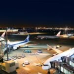 Tokyo, Japan: Japan's two largest airlines, Japan Airlines (JAL) and All Nippon Airways (ANA), have raised fuel surcharges on international passenger tickets purchased during July and August 2026, with charges exceeding ¥65,000 (around US$400) on some long-haul routes despite a sharp decline in jet fuel prices across Asia. The increase, which took effect on July 1, reflects the airlines' long-standing fuel surcharge calculation methodology that relies on historical average fuel prices rather than prevailing market rates. Both carriers revise their international fuel surcharges every two months. According to JAL, the revised surcharge is based on the average Singapore kerosene-type jet fuel price during April and May 2026, when fuel averaged US$178.21 per barrel. Since then, jet fuel prices have fallen substantially, dropping to US$113 per barrel on July 2, according to LSEG data. The decline follows an unprecedented spike that saw prices surge to a record US$242 per barrel in late March amid heightened geopolitical tensions in the Middle East. Because the surcharge calculation uses a two-month averaging mechanism with a lag, the recent decline in fuel prices will not be reflected until the next revision. As a result, passengers purchasing tickets in July and August will continue to pay significantly higher fuel surcharges despite easing fuel markets. JAL said the surcharge could have been even higher if not for financial support provided by the Japanese government to offset soaring energy costs resulting from the conflict involving Iran. Under the airline's pricing formula, the April-May average fuel price would have placed the surcharge in a higher pricing band. However, government mitigation measures reduced the applicable surcharge level, preventing passengers from paying the maximum allowable amount. For the July-August ticketing period, JAL's highest one-way fuel surcharge is ¥65,000 for flights between Japan and North America (excluding Hawaii), Europe, the Middle East and Oceania. Similar surcharge levels have also been introduced by ANA. The increase marks a sharp rise in travel costs over recent months. According to ANA's published surcharge tables, fuel levies on routes connecting Japan with Hawaii, India and Indonesia have more than tripled since the outbreak of the Iran conflict, increasing from US$94 in April to US$310 in July. JAL's surcharge structure reflects similar increases across comparable international routes. Although crude oil and jet fuel prices have retreated considerably from their March highs, the depreciation of the Japanese yen has continued to add pressure on airline operating costs. The yen fell to a 40-year low against the U.S. dollar earlier this week, making dollar-denominated fuel purchases more expensive for Japanese carriers and pushing the value of the highest surcharge to approximately US$400. JAL calculates its fuel surcharge using two key variables: the average price of Singapore kerosene-type jet fuel and the average exchange rate between the Japanese yen and the U.S. dollar during the applicable assessment period. For the July-August revision, the airline used an average exchange rate of ¥158.85 per U.S. dollar, translating the fuel price into a yen-denominated benchmark used to determine the surcharge band. The airlines review international fuel surcharges every two months, meaning the significant decline in fuel prices recorded during June and July is expected to be reflected in the September-October surcharge revision. If fuel prices remain near current levels, passengers purchasing tickets during that period are expected to benefit from lower fuel surcharges. The surcharge increase comes as international travelers to Japan are already facing higher travel-related costs introduced on July 1. Japan increased its international departure tax from ¥1,000 to ¥3,000 (approximately US$18) per passenger, while visa fees rose from ¥3,000 to ¥15,000 (around US$92), marking the first increase in visa charges since 1978. The combined effect of higher fuel surcharges, increased departure taxes and revised visa fees is expected to raise the overall cost of international travel to and from Japan during the peak summer travel season, even as global aviation fuel prices continue to decline. According to JAL, the current surcharge levels remain temporary and will continue to be reviewed under its bi-monthly pricing mechanism based on prevailing fuel market conditions and exchange rates.