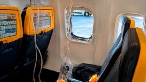 Thessaloniki, Greece: A Ryanair flight bound for Germany was forced to make an emergency return to Thessaloniki shortly after take-off on July 10, 2026, after a cabin window became dislodged during flight, triggering a rapid depressurization and injuring a passenger seated beside the window. The Boeing 737 Next Generation aircraft had departed Thessaloniki Airport in Greece on a scheduled service to Memmingen, Germany, when the incident occurred during the initial climb. Preliminary reports indicate the aircraft had climbed to between 16,000 and 20,000 feet when the crew declared an emergency and turned back toward Thessaloniki. According to multiple media reports citing investigators and aviation officials, the emergency is believed to have begun with a reported uncontained failure of the aircraft's right CFM56 engine. Investigators are examining whether debris from the engine struck the fuselage and dislodged a passenger window, causing a sudden loss of cabin pressure. The sequence of events remains under investigation and has not yet been confirmed by authorities. The rapid decompression caused passenger oxygen masks to deploy automatically. Videos recorded inside the cabin and shared on social media showed masks hanging from the ceiling and a damaged window after the incident. A 61-year-old Serbian passenger, who was seated next to the affected window and was wearing his seatbelt, was partially pulled through the opening created by the dislodged window during the decompression. Fellow passengers, including his wife, immediately grabbed him and managed to pull him back into the cabin before the aircraft landed safely. Reports state he suffered non-life-threatening injuries, including friction burns, and was transported to hospital after landing. Authorities have not publicly identified the hospital where he was treated. The aircraft landed safely back at Thessaloniki Airport approximately 10 to 20 minutes after departure. Emergency services met the aircraft on arrival, and the injured passenger received medical treatment. The remaining passengers later continued their journey to Memmingen aboard a replacement Ryanair aircraft. The aircraft involved has remained grounded for technical inspection following the incident. The investigation is being led by North Macedonia's Accident Investigation Committee, with assistance from the U.S. National Transportation Safety Board (NTSB), Boeing and engine manufacturer CFM International, reflecting the multinational nature of the aircraft, engine and operator involved. In a statement, Ryanair confirmed the in-flight occurrence, saying: "A window became dislodged during the flight." The airline added that the aircraft returned to Thessaloniki and landed normally, and that passengers were returned to the terminal before continuing their journey on a replacement aircraft. Ryanair has not confirmed media reports suggesting the passenger was partially pulled outside the aircraft, while the cause of the window failure remains under investigation. The Irish Aviation Authority (IAA) also confirmed it is aware of the occurrence and said it is coordinating with the relevant Greek and Maltese aviation authorities as the investigation continues.