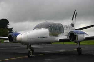 Alaska, United States: A twin-engine Cessna 441 charter aircraft carrying eight people crashed near the remote Cape Newenham Long Range Radar Site in western Alaska on Thursday, August 20, while approaching Cape Newenham. The aircraft, operated by Security Aviation, had departed Ted Stevens Anchorage International Airport and was headed to Cape Newenham when it went down west of Cape Newenham LRRS Airport at about 12:15 p.m. local time. NTSB Alaska region chief Clint Johnson confirmed that two pilots and six passengers were aboard, but officials had not released their condition or confirmed any fatalities or survivors at the time of reporting. The Alaska Rescue Coordination Center launched a search-and-rescue mission after receiving a report of an “aircraft incident” near the Cape Newenham Long Range Radar Site. Johnson, the NTSB’s Alaska region chief, provided the passenger and crew count to The Associated Press and said he did not immediately have details on the status of those aboard. AP reported that Johnson said the aircraft was believed to have crashed early Thursday afternoon while on approach to Cape Newenham. “The information received so far is preliminary,” Johnson said. According to the FAA, the aircraft crashed west of Cape Newenham LRRS Airport at 12:15 p.m. local time. The Cessna 441 is a twin-engine turboprop aircraft. Security Aviation, an Anchorage-based charter operator, lists the Cessna 441 Conquest II among its fleet and says the aircraft is suited for operations across Alaska, including airports with gravel runways and challenging weather and airport environments. The aircraft was believed to have gone down during its approach to Cape Newenham rather than after landing. However, authorities have not disclosed what caused the aircraft to crash, whether the crew issued an emergency call, whether there was a mechanical problem, or what the weather conditions were at the time of the accident. None of those factors has been identified by investigators as a cause. The crash occurred near the Cape Newenham Long Range Radar Site, a remote facility in western Alaska. The Alaska Rescue Coordination Center said it began a search-and-rescue operation after receiving a report of an “aircraft incident” in the area. Authorities had not publicly confirmed whether rescuers had reached all eight occupants, whether anyone had survived, or whether there were fatalities. NTSB officials also had not released the identities of the pilots or passengers. The lack of information was attributed in part to the remote location of the crash site and the early stage of the response. The NTSB is leading the investigation, with the FAA assisting. Investigators are expected to establish the aircraft’s flight path, examine the wreckage and determine what led to the crash. No cause has been announced, and the NTSB has stressed that the information available so far remains preliminary.