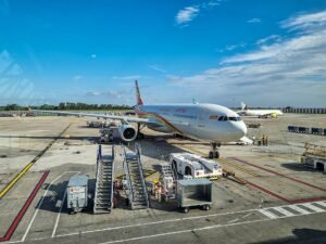 Krasnoyarsk, Russia: Hainan Airlines Flight HU753, operating from Beijing Capital International Airport in China to Manchester Airport in the United Kingdom, diverted to Krasnoyarsk International Airport in Russia on August 15 after the Airbus A330-300 developed a mechanical fault while flying over Siberia. The aircraft landed safely, with no injuries, deaths or damage reported. The flight was operated by an Airbus A330-343, registration B-304L, with 230 people on board. Flight-tracking data showed the aircraft departed Beijing for Manchester and was cruising at approximately FL340, or 34,000 feet, when the problem occurred. The aircraft was around 190 nautical miles southeast of Krasnoyarsk when it descended to approximately FL200 and diverted toward Krasnoyarsk International Airport. According to reports, the problem emerged approximately four hours into the flight. The aircraft's sensors detected the fault and the crew issued an emergency signal before diverting to Krasnoyarsk.. Russian emergency authorities had prepared for the aircraft's arrival, deploying 51 personnel and 15 vehicles. The response included 39 personnel and 11 vehicles from Russia's Ministry of Emergency Situations, according to reports. Emergency teams were positioned as a precaution, but the aircraft completed the landing without an accident. Russia's Emergencies Ministry confirmed that there were no injuries or deaths and that neither the aircraft nor airport infrastructure was damaged. English- and Chinese-speaking airport personnel were also reported to have assisted passengers and crew following the landing. Hainan Airlines confirmed the diversion and apologised to passengers. In its statement, the airline said: “On 15 August 2026, our flight HU753 (Beijing–Manchester) diverted to Krasnoyarsk International Airport in Russia due to a mechanical fault. The flight landed safely at 07:28 Beijing time.” The airline added: “The company plans to replace the aircraft to operate the onward flight. We will properly arrange passenger service support to ensure safe arrival at the destination. We sincerely apologise for any inconvenience caused to passengers.” Hainan Airlines also reiterated: “Hainan Airlines always adheres to the principles of safety first and passengers first, providing safe, comfortable and efficient services.” The exact nature of the mechanical fault has not been officially disclosed. Hainan Airlines described the problem as a “mechanical fault,” while Russian authorities referred to it as a technical malfunction. Therefore, claims that the incident involved a particular system failure should be treated cautiously. The diversion left passengers in Krasnoyarsk while Hainan Airlines arranged an onward journey. The airline said a replacement aircraft would be sent to Krasnoyarsk to continue the service to Manchester, while passenger support arrangements were being made.