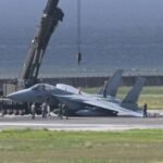 Naha, Japan: A Japan Air Self-Defense Force (JASDF) F-15J fighter jet suffered a landing-gear malfunction while landing at Naha Airport in Okinawa on August 18, forcing the closure of the airport’s second runway for about four hours and delaying dozens of civilian flights. The pilot escaped without injury. The aircraft was identified as a Mitsubishi F-15J Eagle, registration 22-8809. The single-seat fighter was operating from JASDF Naha Air Base and was returning from a scramble mission conducted as part of Japan’s response to a possible airspace intrusion. The incident occurred at around 12:55 p.m. local time as the F-15J landed on Runway 36L, also known as Naha Airport’s B Runway. According to Japan Air Self-Defense Force (JASDF) officials, the aircraft developed a problem involving its landing gear during the landing sequence. The jet subsequently became tilted and stopped on the runway. The precise mechanical cause remains under investigation. Images and video from the scene showed the aircraft resting at an angle, with its left side lowered toward the runway. The occurrence was a possible failure of the left main landing gear. Other reports said the fighter slid along the runway after the gear collapsed, with the aircraft rotating roughly 180 degrees before coming to rest facing in the opposite direction. A JASDF spokesman told Stars and Stripes that the landing gear apparently failed as the aircraft touched down shortly before 1 p.m. and that the fighter’s left wing contacted the runway before it came to a stop. The spokesman said the pilot was not injured and that the extent of damage to the aircraft was still being assessed. The aircraft was eventually removed from the runway using recovery equipment, including a crane. Naha Airport officials said the runway remained closed for approximately four hours while the fighter was removed, the area was cleaned and safety inspections were completed. Runway operations subsequently resumed. The closure had a significant effect on civilian operations because Naha Airport is a dual-use facility, serving both commercial aviation and the JASDF. With the B Runway unavailable, civilian aircraft were required to use the other runway. Airport officials said 40 commercial flights were delayed, with some delays exceeding 30 minutes. The incident also drew a response from Okinawa Governor Denny Tamaki, who described the situation as deeply regrettable and called for the cause of the incident to be investigated. The governor’s office has sought information on the circumstances surrounding the fighter’s landing and measures to prevent a recurrence. The F-15J’s condition and the precise reason for the landing-gear failure remain subject to investigation. At this stage, available official data does not establish whether the malfunction resulted from a particular component failure, maintenance issue or other technical factor.