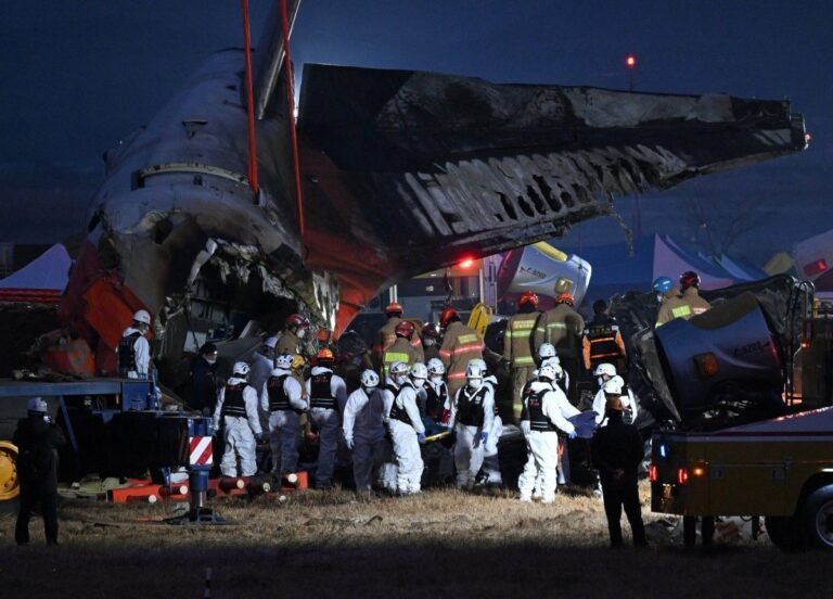 Muan, South Korea: South Korean police on August 11 raided the state-run Korea Airports Corporation (KAC), the Ministry of Land, Infrastructure and Transport and the Busan Regional Office of Aviation as investigators widened their probe into the Jeju Air crash at Muan International Airport that killed 179 people in December 2024. The searches were carried out by a special police investigation team seeking additional evidence over suspected professional negligence resulting in death or injury and possible failures by government agencies and other bodies responsible for airport safety and operations. Police said the investigation is examining both the cause of the December 29, 2024 crash and whether relevant authorities properly performed their duties. A police official said 45 people are currently facing suspicions of professional negligence resulting in death or injury, while investigators are also considering whether charges linked to causing a serious public disaster could be applied. The latest searches targeted KAC, which operates most of South Korea’s major airports except Incheon International Airport, along with the Transport Ministry and the Busan Regional Office of Aviation. The action marks another major phase in a criminal investigation that has continued for more than a year as investigators examine decisions surrounding Muan Airport’s construction, safety oversight, airport infrastructure and the response to the crash. The crash involved Jeju Air Flight 7C2216, a Boeing 737-800 operating from Bangkok to Muan. The aircraft was carrying 181 people when it attempted an emergency landing at Muan International Airport on December 29, 2024. After a bird-strike-related emergency, the aircraft landed without its landing gear deployed, slid along the runway and struck a concrete structure supporting a localizer antenna before breaking apart and catching fire. Only two crew members survived, while 179 passengers and crew members were killed. The criminal investigation has increasingly expanded beyond the aircraft itself to possible institutional and infrastructure failures. Police have been examining events dating back to the construction of Muan Airport in 1999 to determine whether decisions made during the airport’s development created conditions that contributed to the disaster. In February 2026, the special investigation team raided the Busan Regional Office of Aviation and a company involved in construction at Muan Airport, seeking evidence connected to possible contributing factors. At that stage, police had booked 45 people on suspicion of occupational negligence and were examining whether the Serious Accidents Punishment Act’s provisions concerning a serious public disaster could apply. The investigation was further expanded in March, when police raided the Transport Ministry to obtain additional material concerning the crash and the conduct of government agencies. Investigators specifically examined whether officials responsible for aviation navigation and airport operations had properly carried out their duties. Police said the probe was looking for factors dating back to the beginning of Muan Airport’s construction. A major development came in March 2026 when South Korea’s Board of Audit and Inspection identified serious shortcomings in the approval and management of airport safety infrastructure. The state auditor found that the Transport Ministry had approved 14 non-compliant localizer installations at eight airports, including Muan, and that some installations had been certified as meeting frangibility requirements despite not doing so. The audit identified 30 cases of wrongdoing or procedural failure, including shortcomings in bird-strike prevention and aviation safety management. At Muan, investigators found that a 2.4-metre-high concrete embankment supporting the localizer had been built partly to reduce construction costs because the terrain around the runway and Runway End Safety Area was sloped. The Board of Audit and Inspection said the structure had been approved by the Transport Ministry in 2003 without an adequate vulnerability assessment. Korea Airports Corporation later requested a review of the structure in 2007, but no changes were made. The structure was subsequently reinforced during a modernization project between 2019 and 2024. International aviation standards call for localizer installations in areas exposed to aircraft impact to be designed so that they can break apart rather than present a rigid obstacle. The state audit found that the ministry had continued to certify such installations and approve inspections that incorrectly indicated compliance for periods extending as long as 22 years. The Transport Ministry said it “humbly accepted” the audit findings and said it would take strict follow-up measures, including improvements to localizer structures and stronger bird-strike prevention. Korea Airports Corporation also said it was implementing improvements recommended in the audit. The infrastructure findings have become particularly significant because a separate government-commissioned simulation examined what might have happened had the concrete embankment not been present at the end of the runway. The simulation, cited in January 2026 reporting, suggested the outcome could have been substantially different without the rigid structure. The findings intensified scrutiny of how the localizer installation was designed and approved. The criminal probe is also unfolding alongside a renewed examination of the accident investigation itself. In May 2026, President Lee Jae Myung visited Muan International Airport after additional human remains were discovered during renewed recovery operations more than a year after the crash. He called for a thorough reinvestigation and criticised shortcomings in the original recovery process. “Given the size and condition (of the additional remains), they should not have been overlooked,” Lee said, adding that “the lax handling of the scene was clearly a problem.” He also instructed officials to consider using outside experts for the reinvestigation. The renewed investigation followed concerns that the original recovery operation had not fully recovered victims’ remains and that officials lacked adequate procedures and oversight. The discovery of additional remains prompted the government to revisit not only the recovery process but also the wider handling of the disaster. The technical investigation into the crash had earlier established evidence of a bird strike. A preliminary accident report released in January 2025 found feathers and blood stains in both engines of the Boeing 737-800. DNA testing identified the remains as Baikal teals, migratory ducks that winter in South Korea. The report, however, did not establish that the bird strike alone caused the crash. It also noted that the flight data recorder and cockpit voice recorder stopped recording about four minutes before impact, leaving critical portions of the final sequence unavailable. The preliminary investigation said authorities would conduct further examinations of the engines, recorders, air traffic control data, bird-strike evidence and the localizer structure. Subsequent reporting in July 2025 cited a source familiar with the investigation as saying there was “clear evidence” that the pilots shut down the less-damaged engine after the bird strike. However, that finding was part of the continuing technical investigation and was disputed by victims’ families, who questioned aspects of the investigation and its transparency. The crash therefore remains under examination on several fronts: the bird strike and resulting aircraft systems problems, the sequence of cockpit decisions, the loss of recorder data, the runway and airport infrastructure, the approval and maintenance of the localizer structure, bird-strike prevention, regulatory oversight and the actions of government agencies before and after the accident. The August 11 raids represent the latest step in the separate criminal investigation into potential responsibility and negligence. Police are now seeking additional records from the organisations responsible for airport operation, aviation oversight and infrastructure, while considering whether the conduct of officials and other responsible parties could amount to professional negligence or a serious public disaster offence. The full accident investigation has yet to provide a final public account resolving all outstanding questions surrounding the crash. The latest police action, coming after the state audit findings and the government's renewed examination of the crash site, places greater focus on whether failures in airport design, regulatory approval, safety oversight or emergency response contributed to the scale of the tragedy.