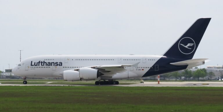 Munich, Germany: A Lufthansa Airbus A380-800 operating flight LH459 from San Francisco International Airport to Munich Airport touched down prematurely near the eastern threshold of Munich’s southern runway on Monday evening, August 17, 2026, damaging runway-threshold lighting. The aircraft, registered D-AIML, was carrying 351 passengers after completing the approximately 11-hour transatlantic flight from San Francisco, United States, to Munich, Germany. All passengers and crew were able to leave the aircraft normally, with no injuries reported. Flight records identify D-AIML as an Airbus A380-841 operated by Lufthansa, while Lufthansa’s published schedule confirms LH459 operates between San Francisco and Munich. According to Lufthansa, the aircraft touched down on the concrete surface before the white-marked runway threshold. During the premature touchdown, the aircraft struck lighting installed around the runway threshold, causing damage to the runway’s visual guidance system. Lufthansa spokesperson Jörg Waber said in a statement, “We can confirm that an AirVIbus A380-800 damaged runway lighting in the area of the runway threshold.” He added that the aircraft had arrived from San Francisco with 351 passengers, subsequently taxied to its assigned position and that all passengers left the aircraft normally. The incident occurred on Munich Airport’s southern runway, identified as Runway 26L when used for approaches from the east. The Deutsche Flugsicherung describes Runway 26L as Munich’s southern runway and says aircraft approaching it from the east use its instrument landing system. Munich Airport characterized the infrastructure damage as minor. According to the airport, a “minor damage” to lighting was identified around the eastern threshold of the southern runway. The damaged lighting was repaired promptly, allowing the runway to return to service less than an hour after the A380 landed. The exact circumstances that caused the A380 to touch down before the designated threshold remain unclear. No official finding has attributed the event to pilot error, weather, aircraft malfunction, runway conditions or any problem with the airport’s approach system. The aircraft touched down short of the marked threshold and that its landing gear struck approach lights. The cause remains under investigation. Germany’s Federal Bureau of Aircraft Accident Investigation, or BFU, has opened an investigation into the occurrence. The A380 involved was approximately 13 years old and carried the registration D-AIML. Flight-history records identify the aircraft as an Airbus A380-841 operated by Lufthansa. The airline’s A380 configuration can accommodate up to 509 passengers, although 351 passengers were onboard LH459 during this particular flight. Separately, on August 15, 2026, a Vietnam Airlines Boeing 787-9 bound for Hanoi experienced an unusually long takeoff run at Munich Airport. The aircraft continued accelerating almost to the end of Runway 26L and reportedly travelled about 120 metres beyond the paved surface before becoming airborne. During the extremely late rotation, its rear underside struck the ground, causing a tailstrike and damage to the aft fuselage. After takeoff, warnings for tail contact and low tyre pressure prompted the crew to remain near Munich at around 9,000 feet for about two hours before returning. The aircraft sustained further landing-gear and tyre damage, with several tyres damaged or deflated, and was unable to taxi after landing. It was carrying 271 passengers and 16 crew, all of whom were reported safe. German authorities are leading the investigation, with Vietnamese investigators assisting, while the cause of the unusually prolonged takeoff remains under investigation.