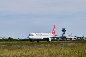 Sydney, Australia: The Australian Transport Safety Bureau (ATSB) has launched an investigation into a serious runway incursion involving two Qantas-operated aircraft at Sydney Airport after an air traffic control clearance resulted in one aircraft being instructed to cross an active runway while another was still landing. The incident occurred on 27 July 2026 at approximately 08:14 local time, and although no collision occurred, the safety watchdog has classified it as a breakdown in coordination and opened a formal investigation. According to the ATSB, the occurrence involved Qantas Flight QF124, a Boeing 737-800 registered VH-XZG, which had arrived from Queenstown, New Zealand, and QantasLink Flight QLK424D, a De Havilland Canada Dash 8 Q400 registered VH-QOC, arriving from Canberra, Australian Capital Territory. Preliminary information released by the ATSB states that after landing on Runway 25, the Boeing 737 was instructed by air traffic control to taxi and cross Runway 34L. At the same time, the Dash 8 Q400 had been cleared to land on Runway 34L and was still completing its landing roll along the active runway. As the Boeing approached the runway crossing point, air traffic controllers recognised the developing conflict. The ATSB said the 737 crew stopped the aircraft before entering Runway 34L, while the Dash 8 continued its landing roll on the runway. Because the Boeing halted short of the runway, the two aircraft remained separated and no collision occurred. No injuries or aircraft damage were reported, and both aircraft subsequently continued normal ground operations. The ATSB has not released the number of passengers or crew on board either flight. The safety bureau has opened investigation AO-2026-086 to determine the factors that led to the runway incursion. Investigators will examine the sequence of air traffic control clearances, coordination between controllers, recorded radio communications, surveillance data, aircraft movements, human factors and operational procedures. The investigation will also assess whether any broader systemic issues contributed to the occurrence. In its initial investigation notice, the ATSB described the event as involving a breakdown of coordination between aircraft movements on intersecting runways. The agency noted that evidence collection is underway, including interviews with relevant personnel and analysis of operational data. A final report is expected before the end of 2026, although the timeline may change depending on investigative findings. The incident has renewed attention on staffing pressures within Australia's air traffic control system. Recent media reports have highlighted controller shortages and increased workload at Sydney Airport, with industry representatives raising concerns over staffing levels. Airservices Australia has acknowledged workforce challenges and said it is recruiting and training additional controllers, while noting that qualification training takes several years before recruits can work independently in complex airspace. Airservices Australia confirmed it is cooperating fully with the ATSB investigation and said safety remains its highest priority. The organisation has not provided further comment while the independent investigation is ongoing. Qantas also confirmed it is assisting the ATSB and stated that both flight crews were operating in accordance with air traffic control instructions issued during the event.